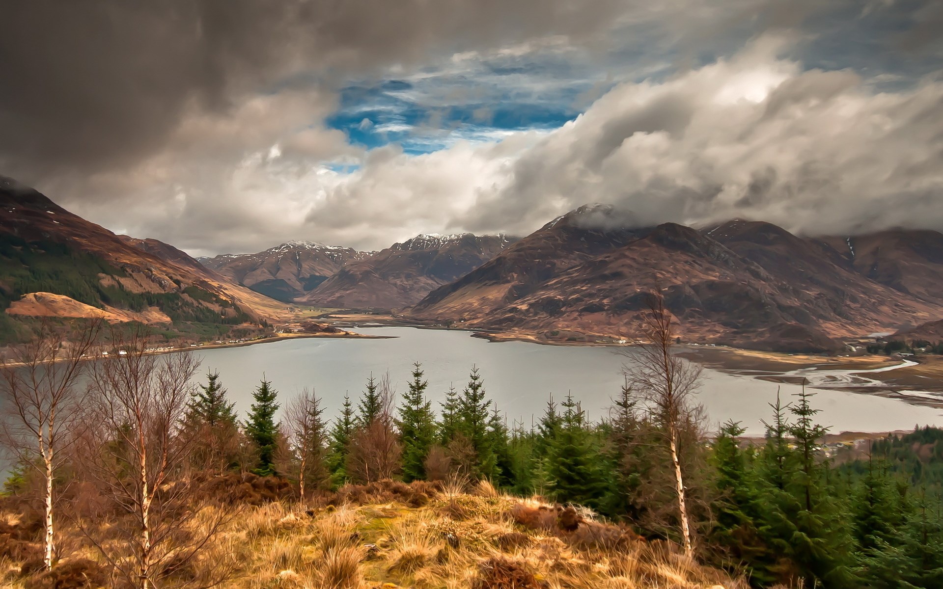 Mountain lake with dramatic clouds and evergreen forest HD Wallpaper