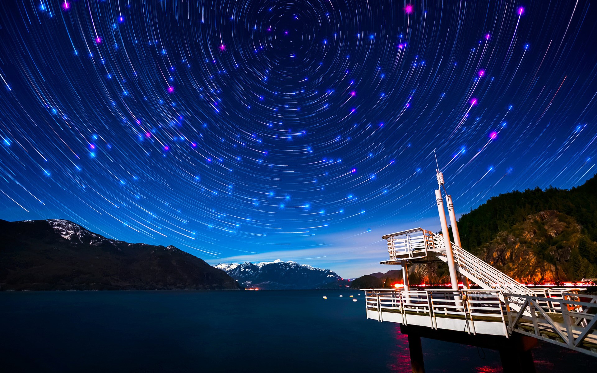 Star trails over a lake and mountains HD Wallpaper