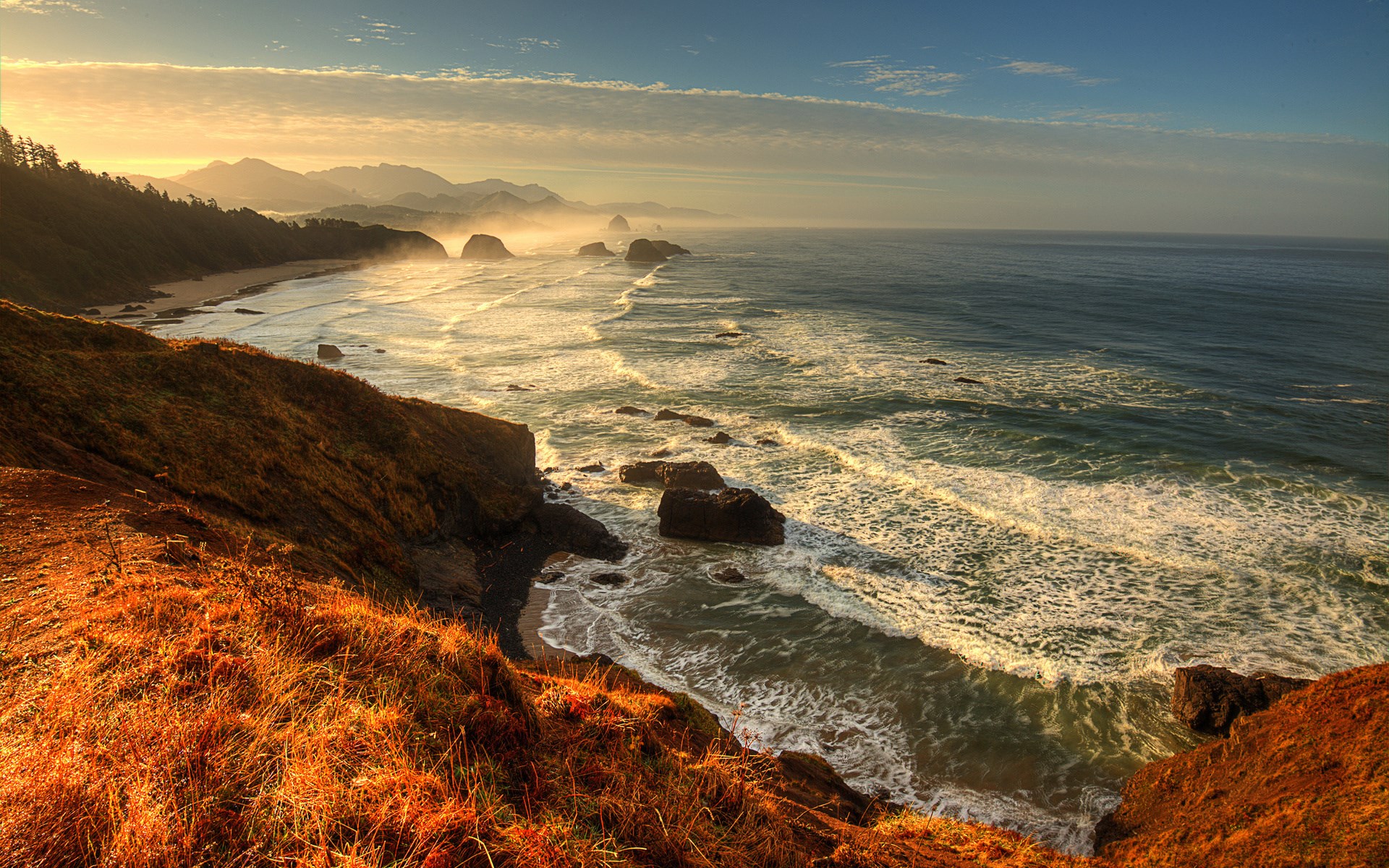 Ocean waves crash on rocky shore at sunset HD Wallpaper