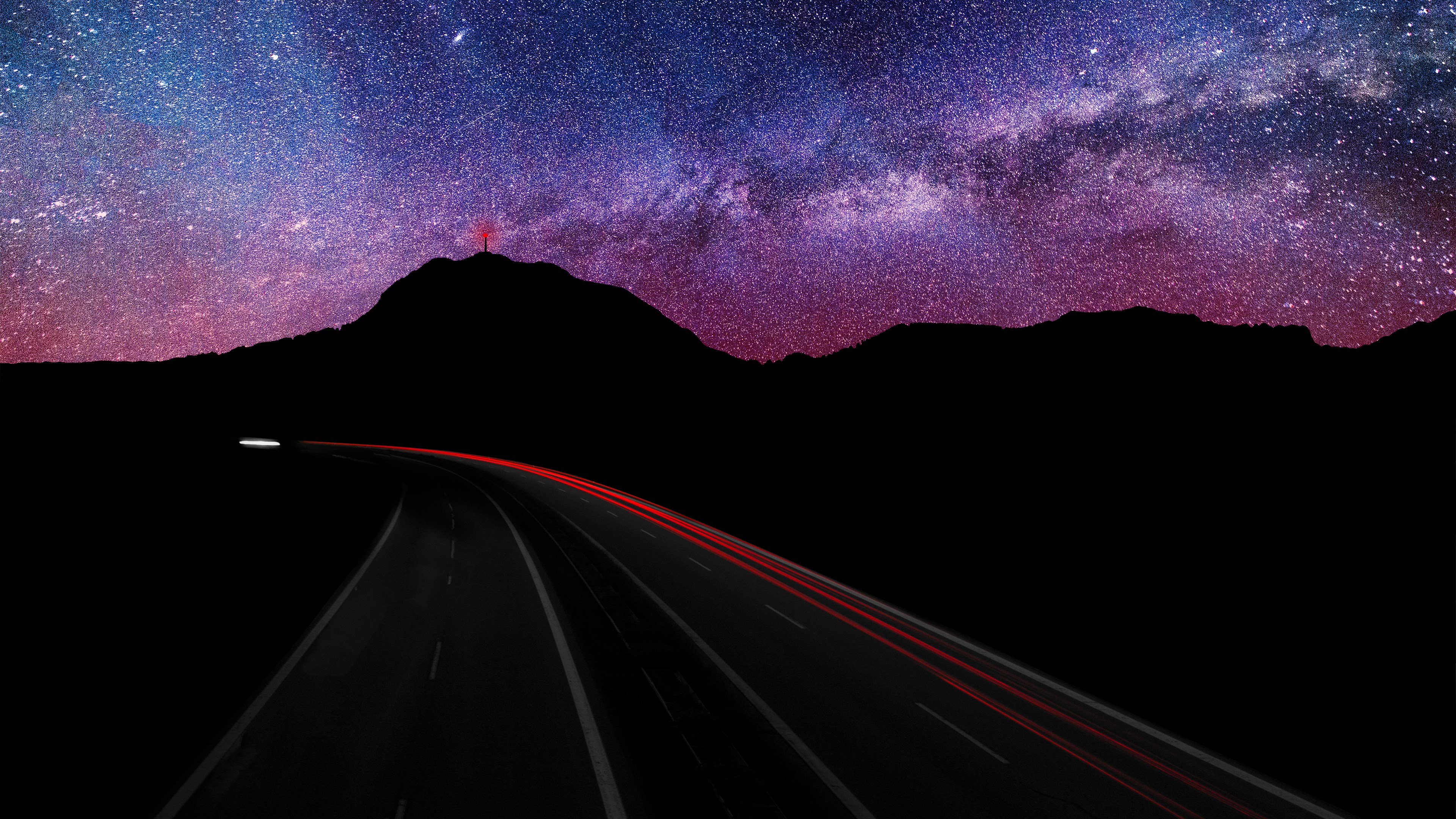 Highway under starry sky with light trails HD Wallpaper