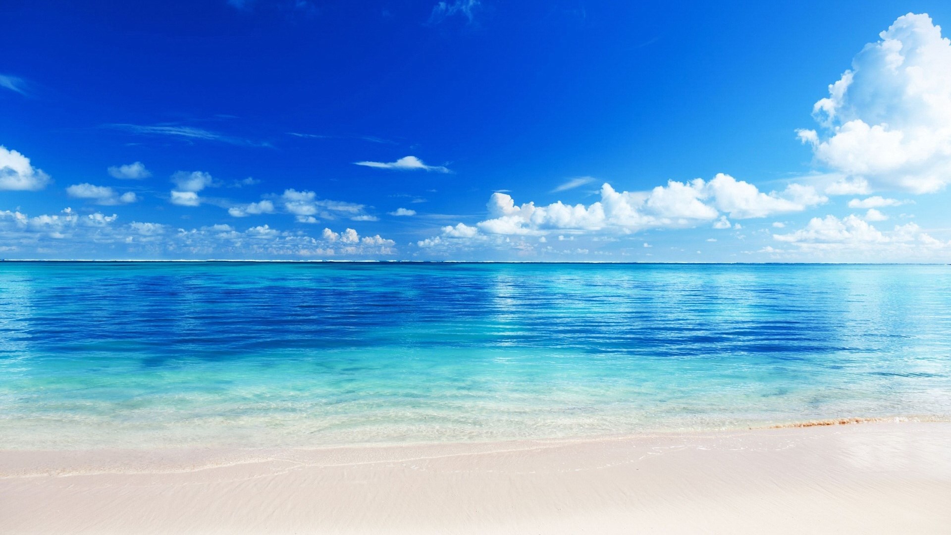 Turquoise ocean and white sand beach under blue sky HD Wallpaper