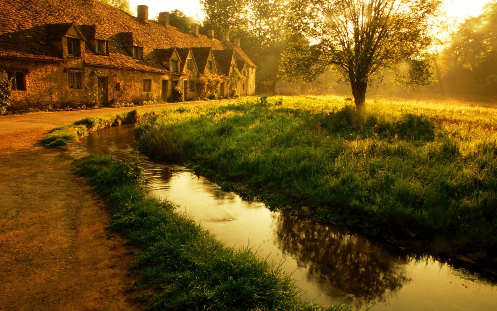 Stone cottages by a stream at sunset HD Wallpaper