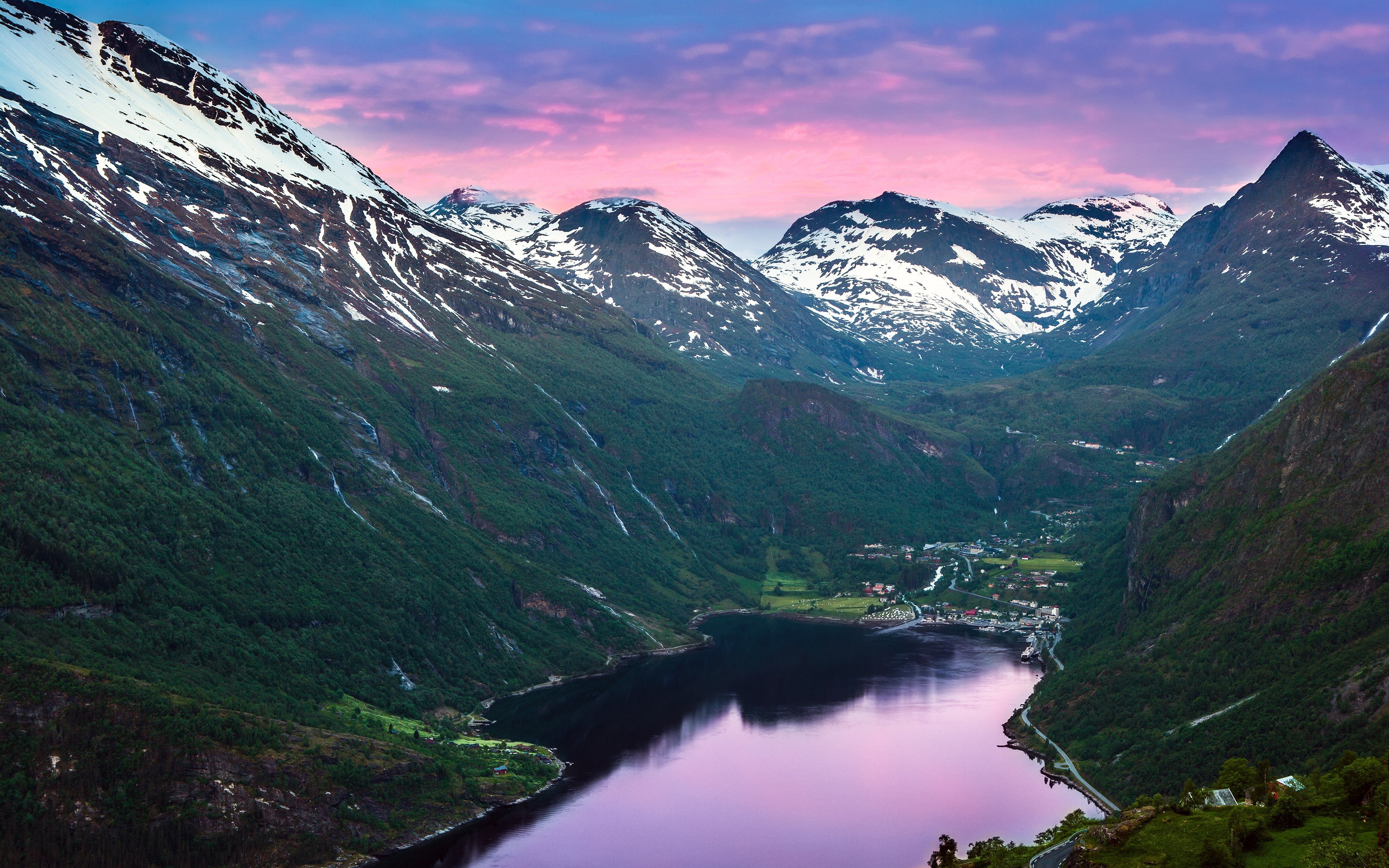Snow-capped mountains overlooking a lake at sunset HD Wallpaper