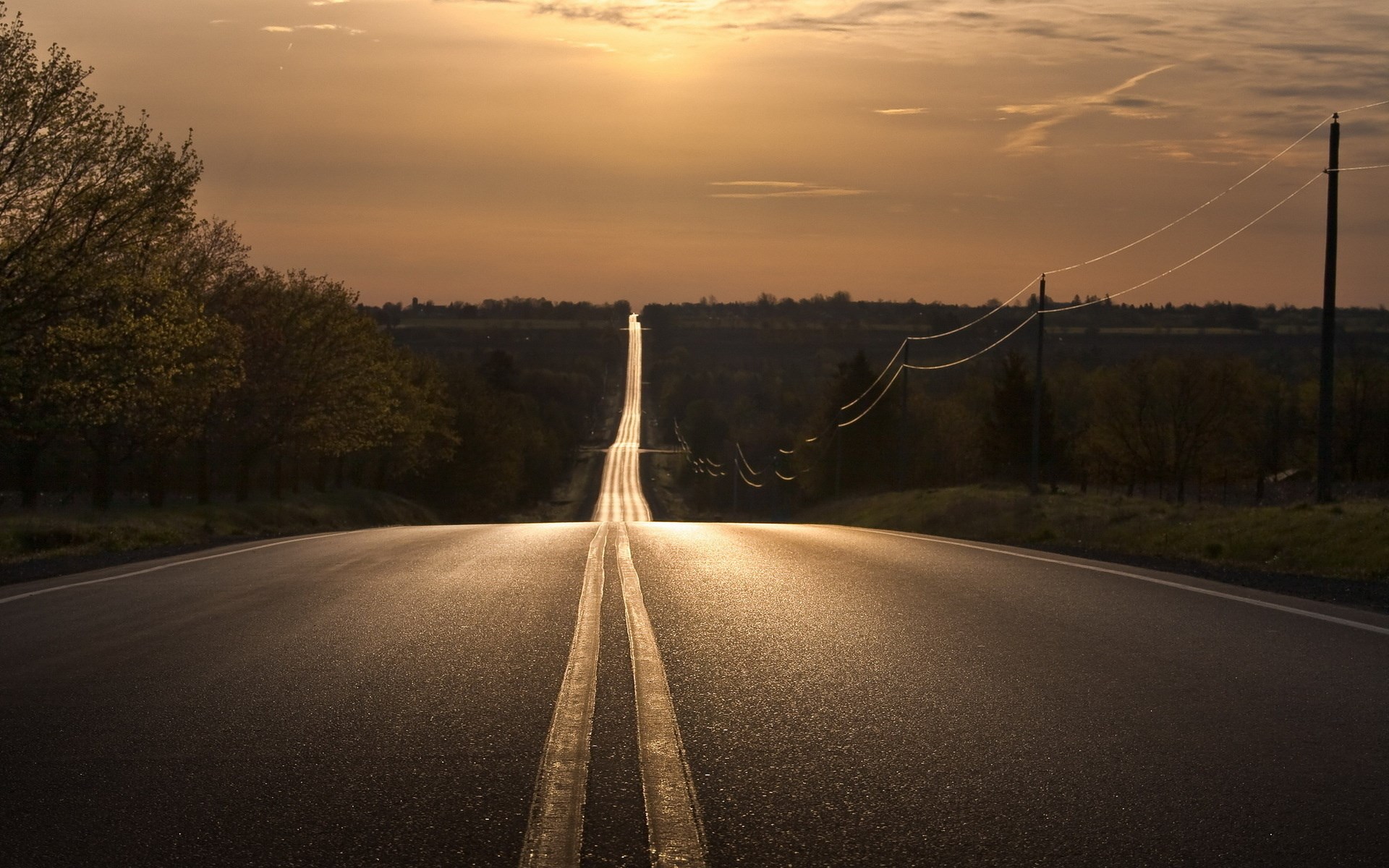 Empty road stretching to the horizon at sunset HD Wallpaper