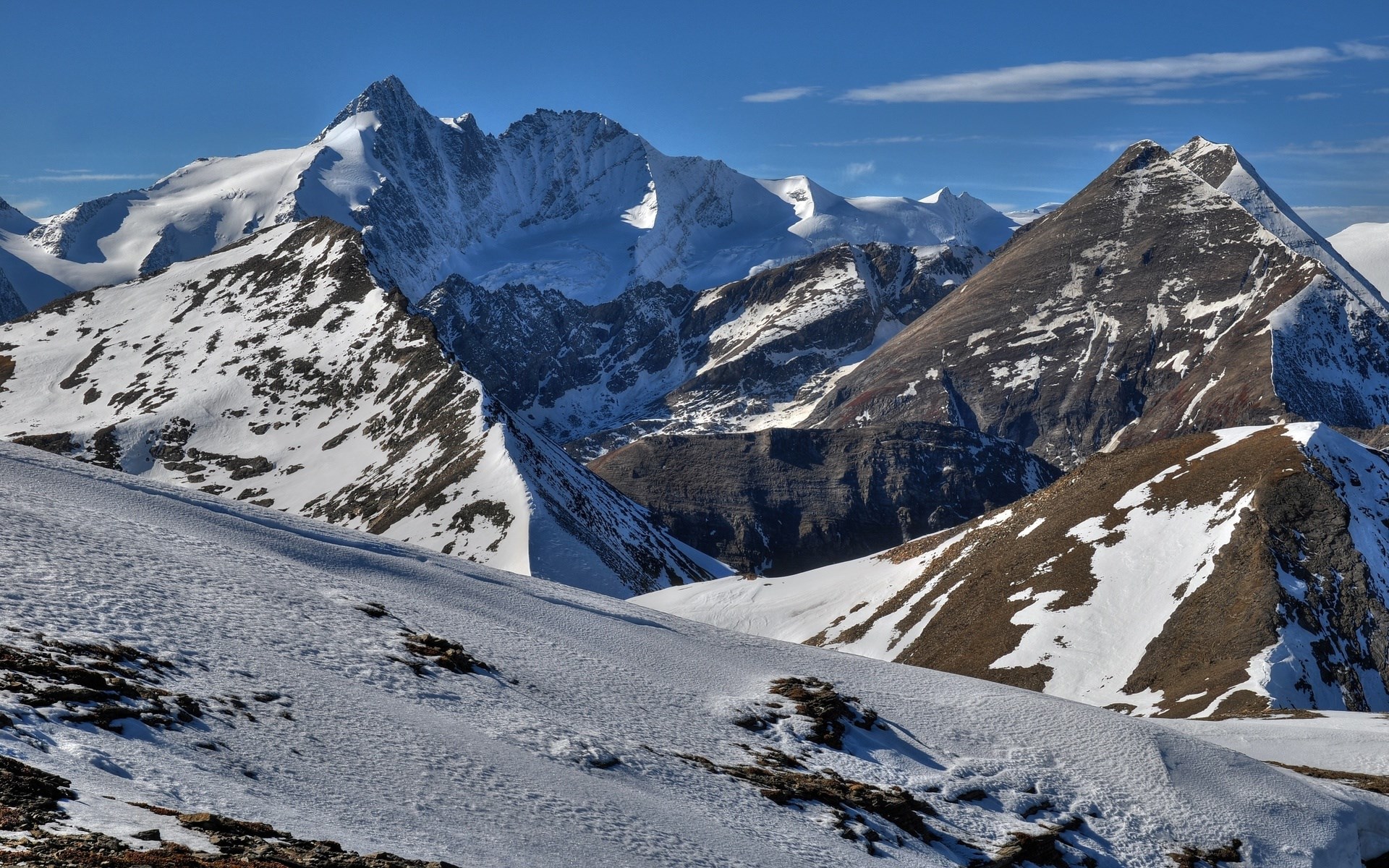 Snow-covered mountains under a clear blue sky HD Wallpaper