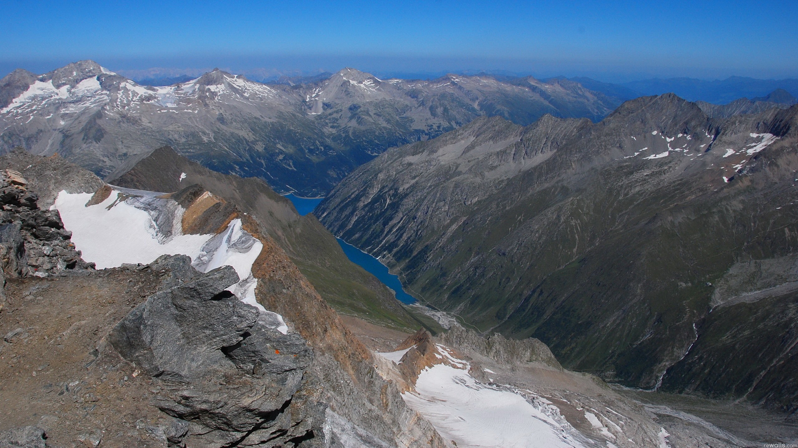 Mountain range with a blue lake in the valley HD Wallpaper
