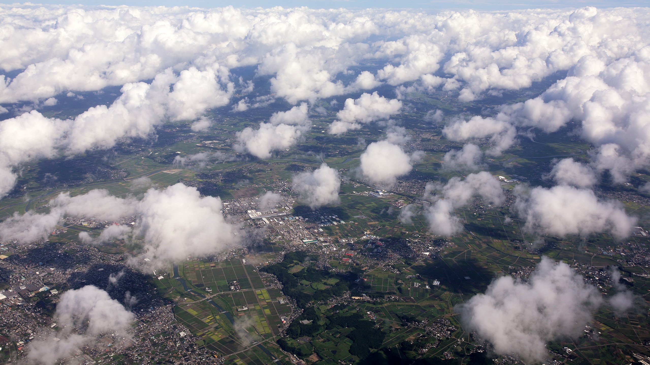 Aerial view of clouds over a landscape HD Wallpaper