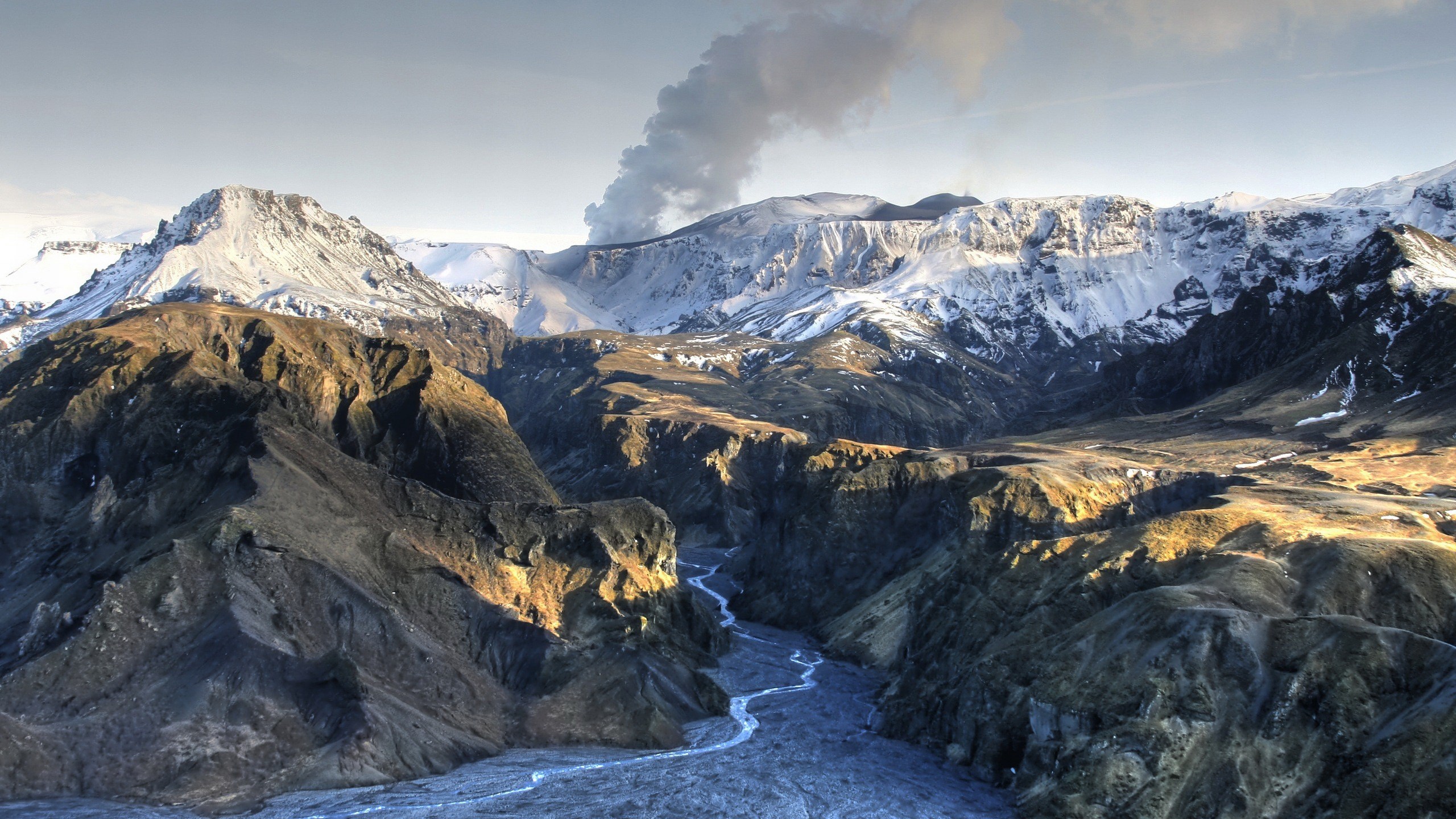 Volcanic eruption in a snowy mountain landscape HD Wallpaper