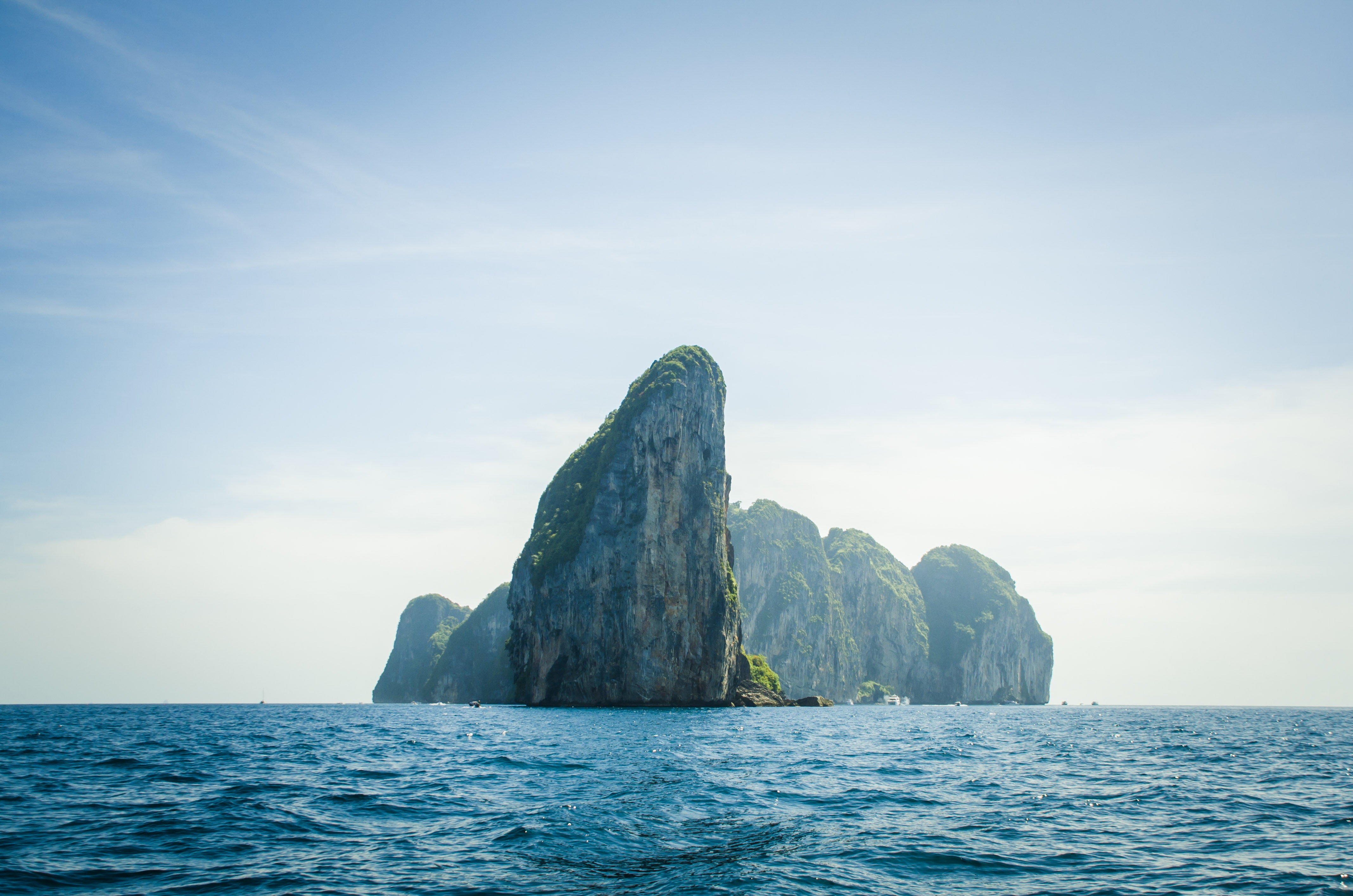 Rocky islands in the ocean under a clear sky HD Wallpaper