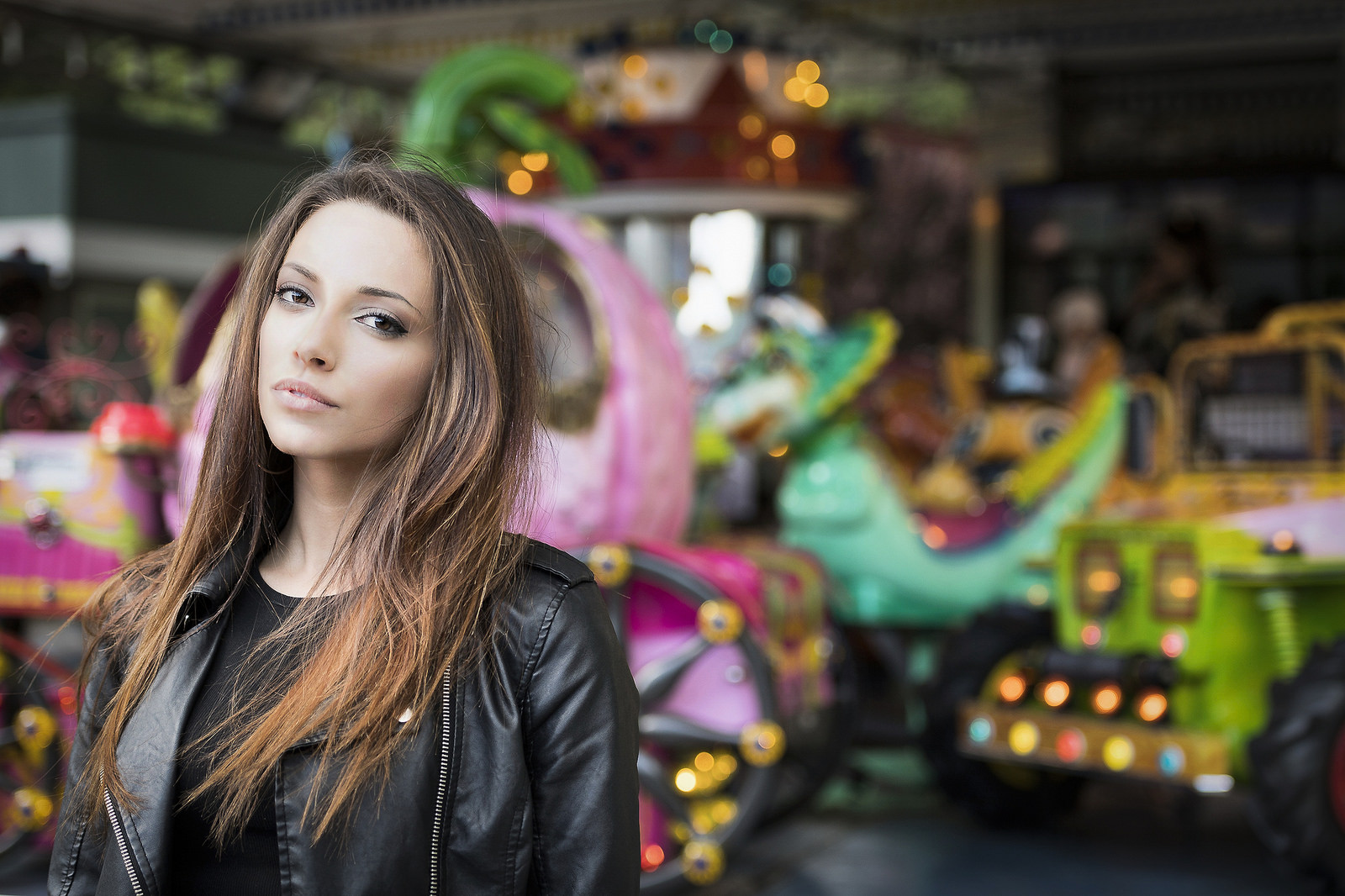 Woman in leather jacket at amusement park HD Wallpaper