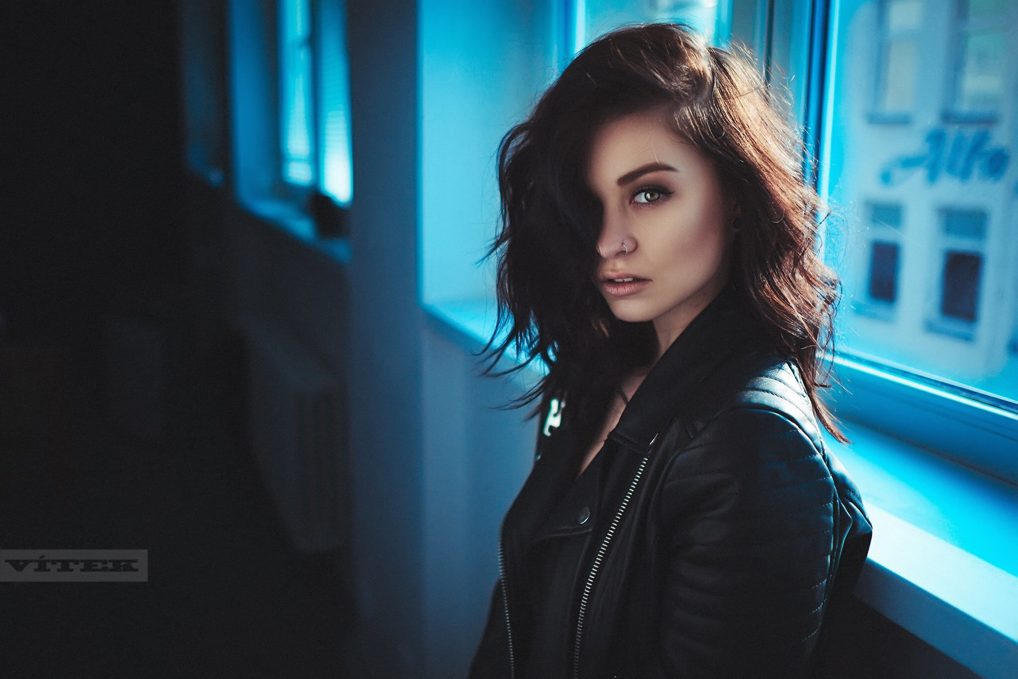 Woman in leather jacket by the window HD Wallpaper