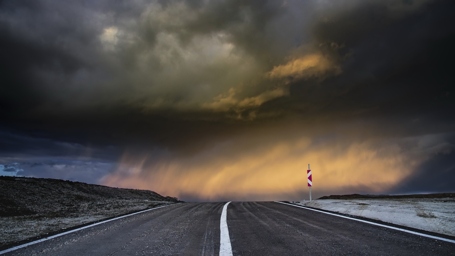 Stormy sky over a road with a warning sign HD Wallpaper