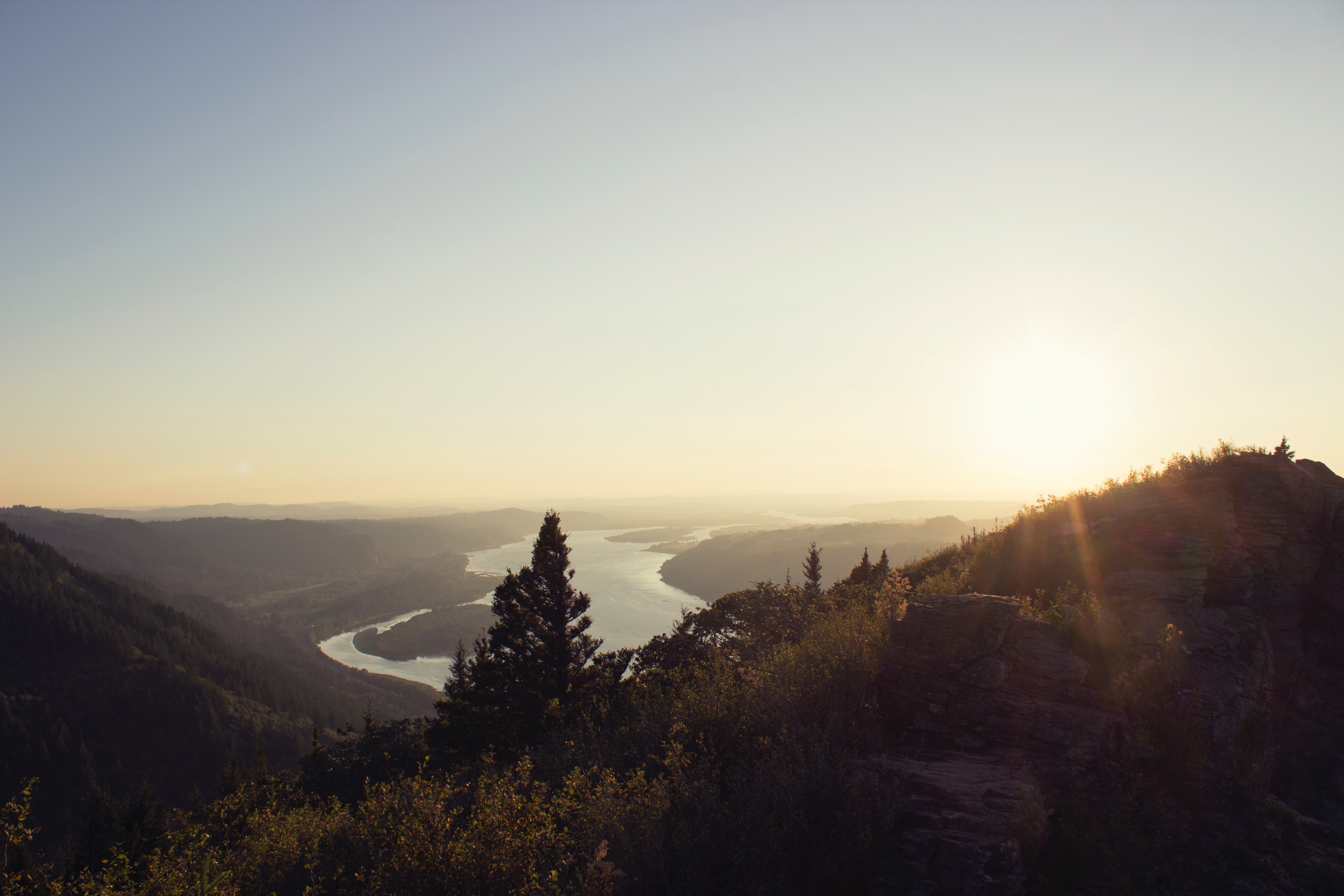 Sunset over a winding river and mountains HD Wallpaper