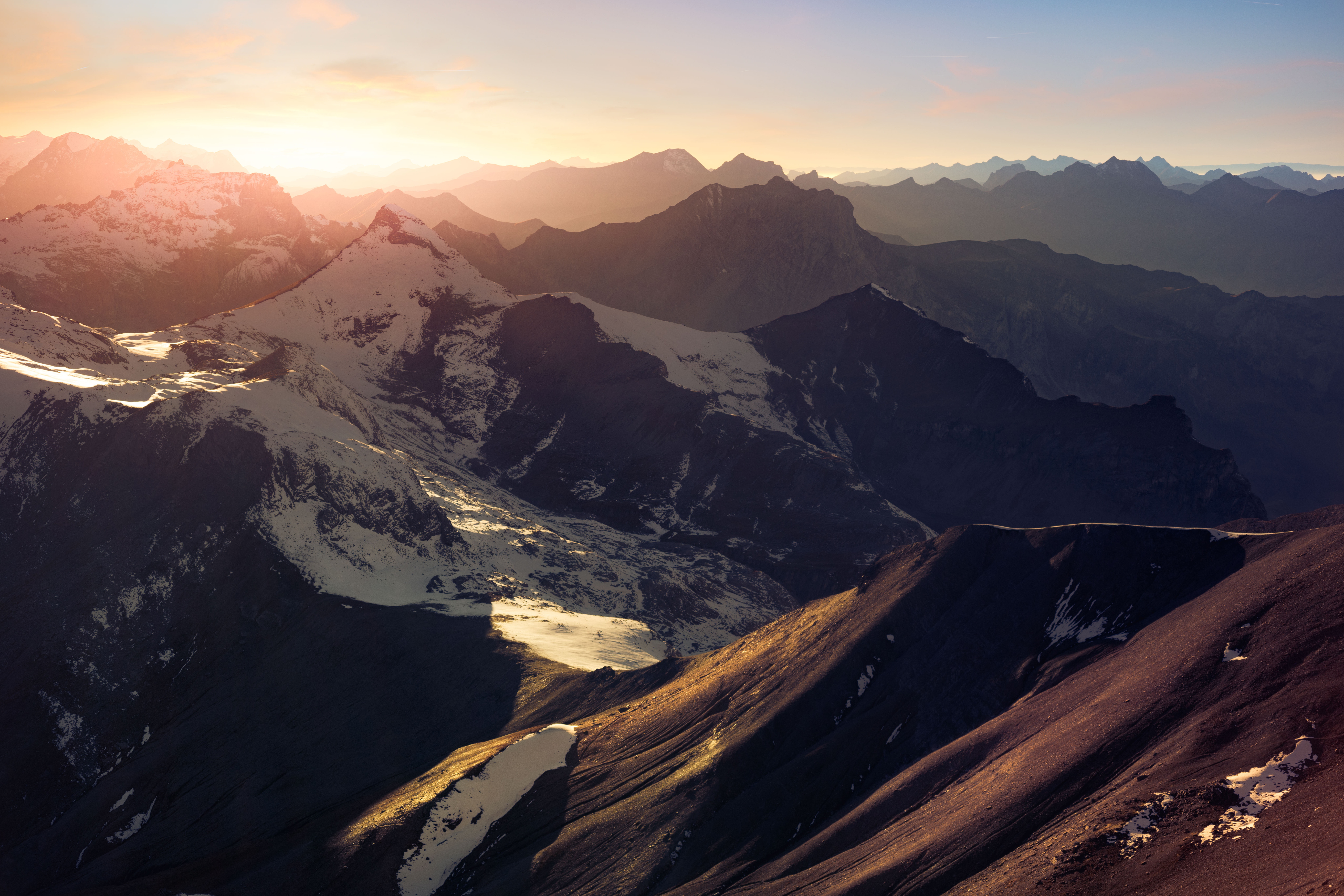 Snowy mountains at sunset in Switzerland HD Wallpaper