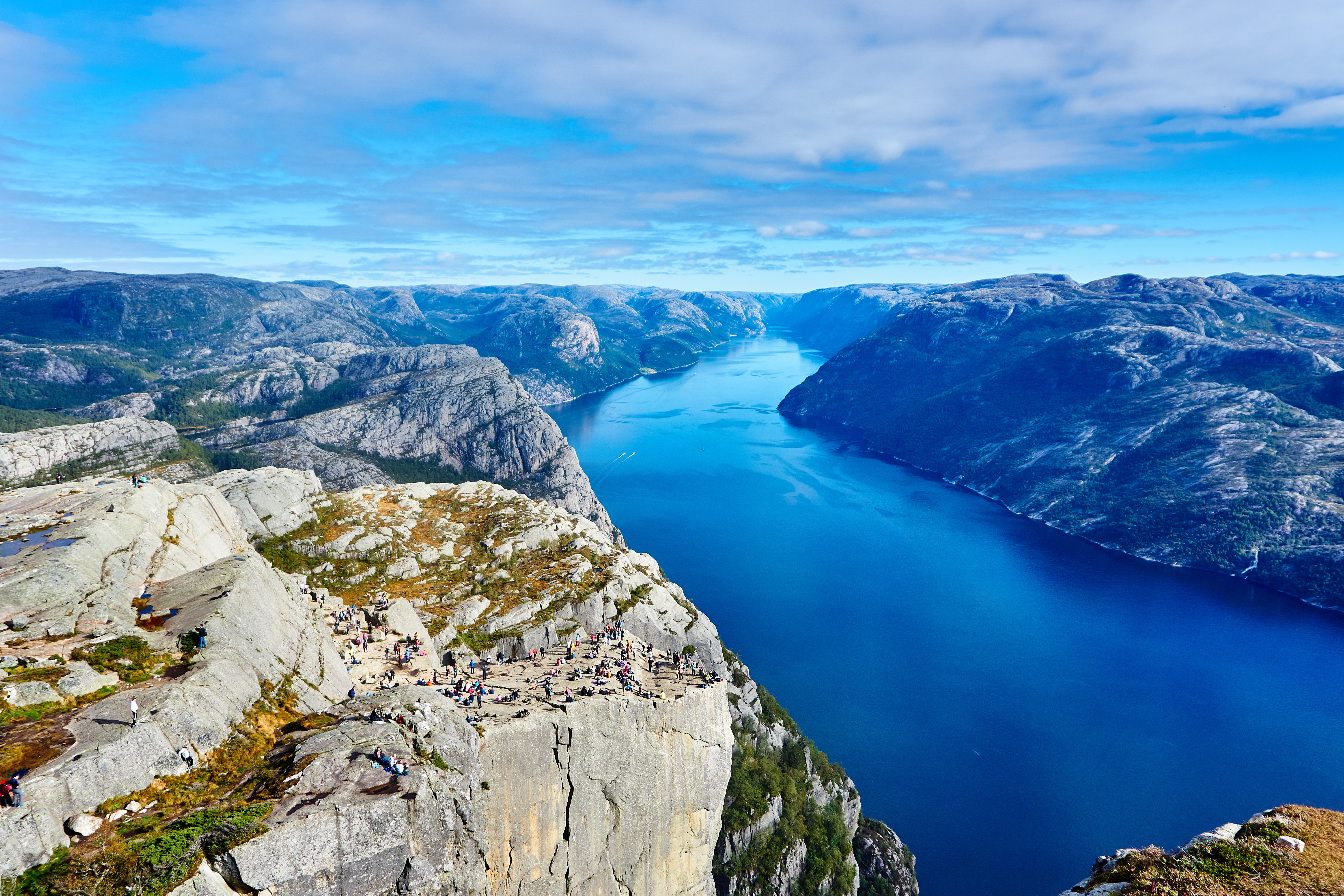 Preikestolen, Norway: Tourists on a cliff overlooking a fjord HD Wallpaper