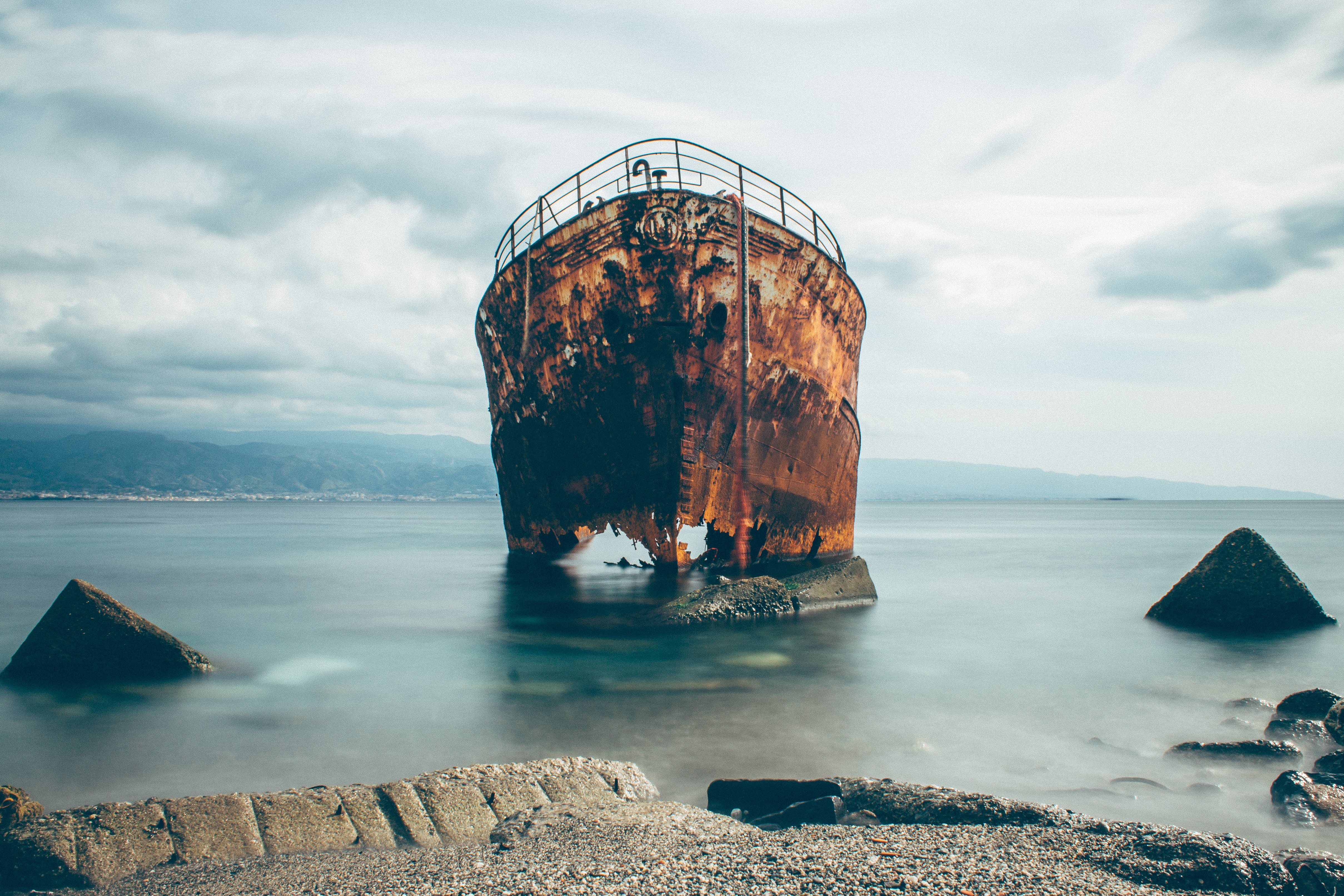 Shipwreck in the sea near Italy with clouds and rocks HD Wallpaper