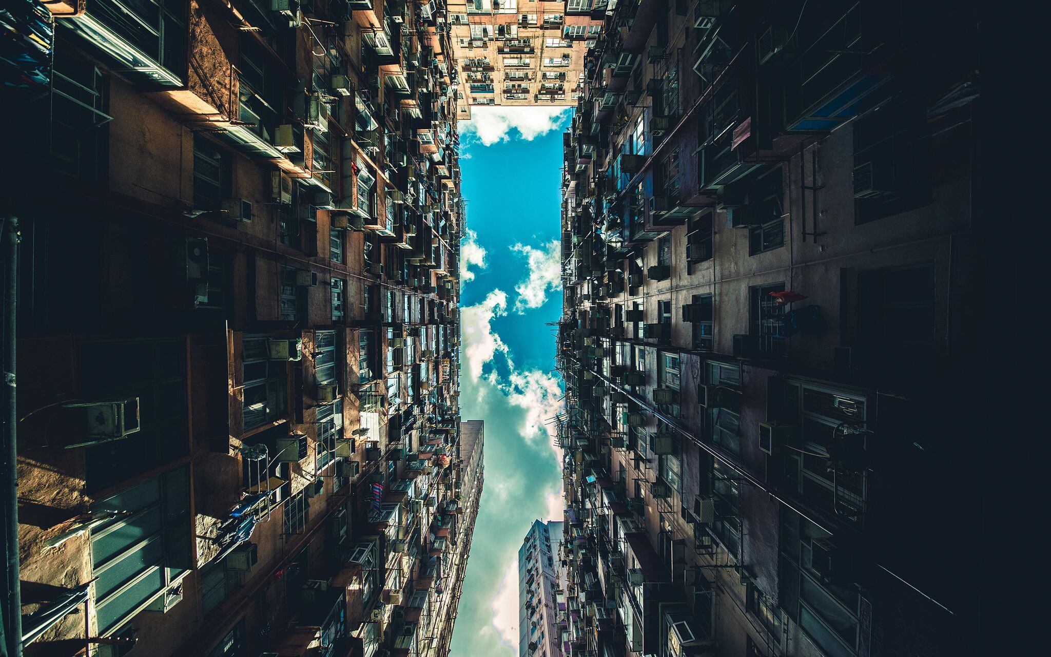 View of dense apartment buildings looking up at the sky HD Wallpaper