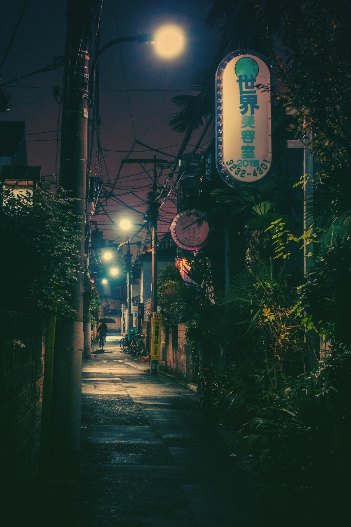Night alley with glowing sign and person on bicycle HD Wallpaper