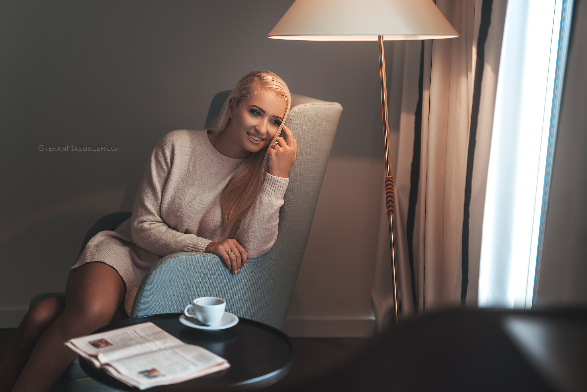 Woman sitting in a chair with a lamp and coffee HD Wallpaper