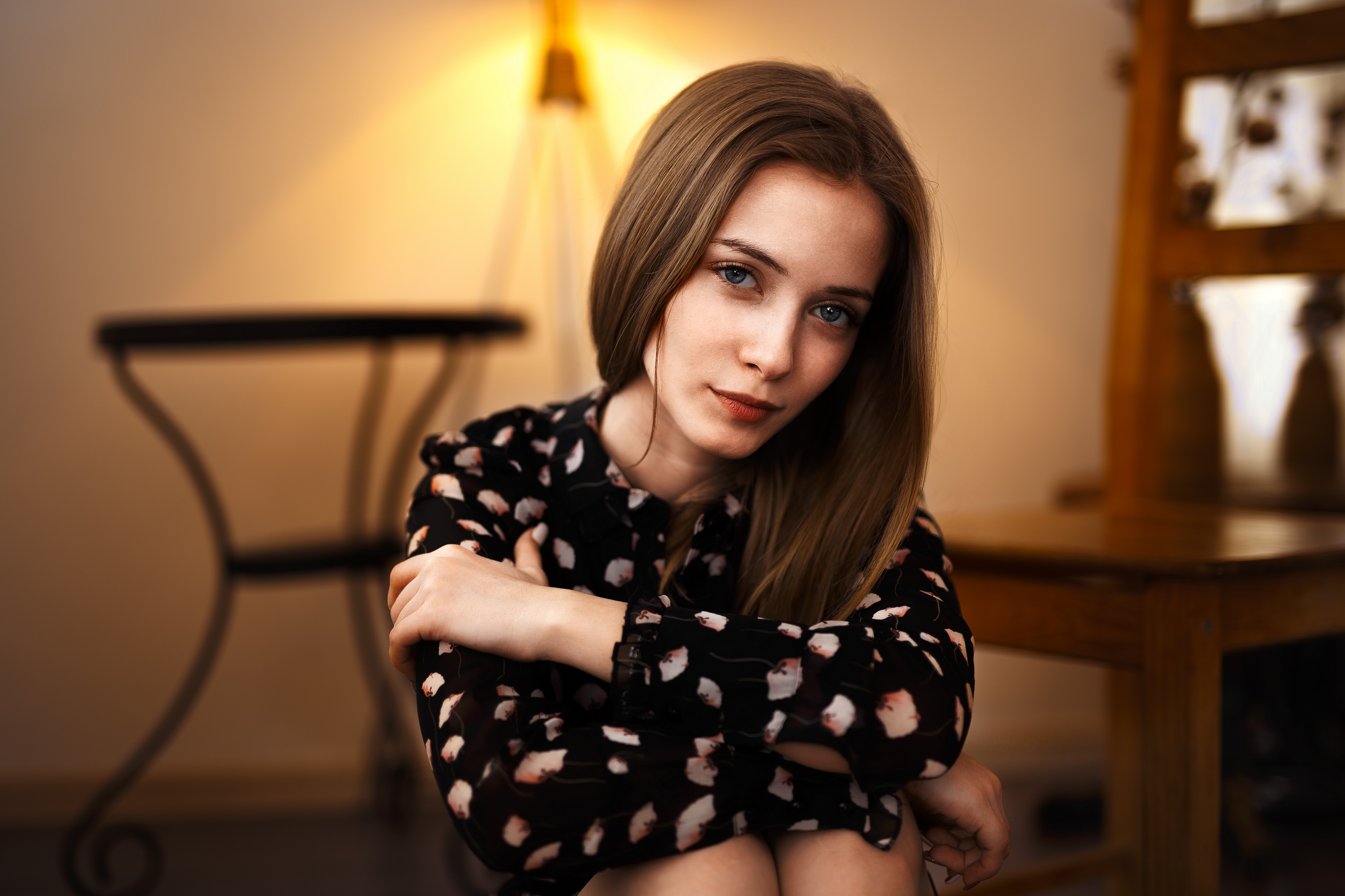 Woman with blonde hair and gray eyes sitting indoors HD Wallpaper