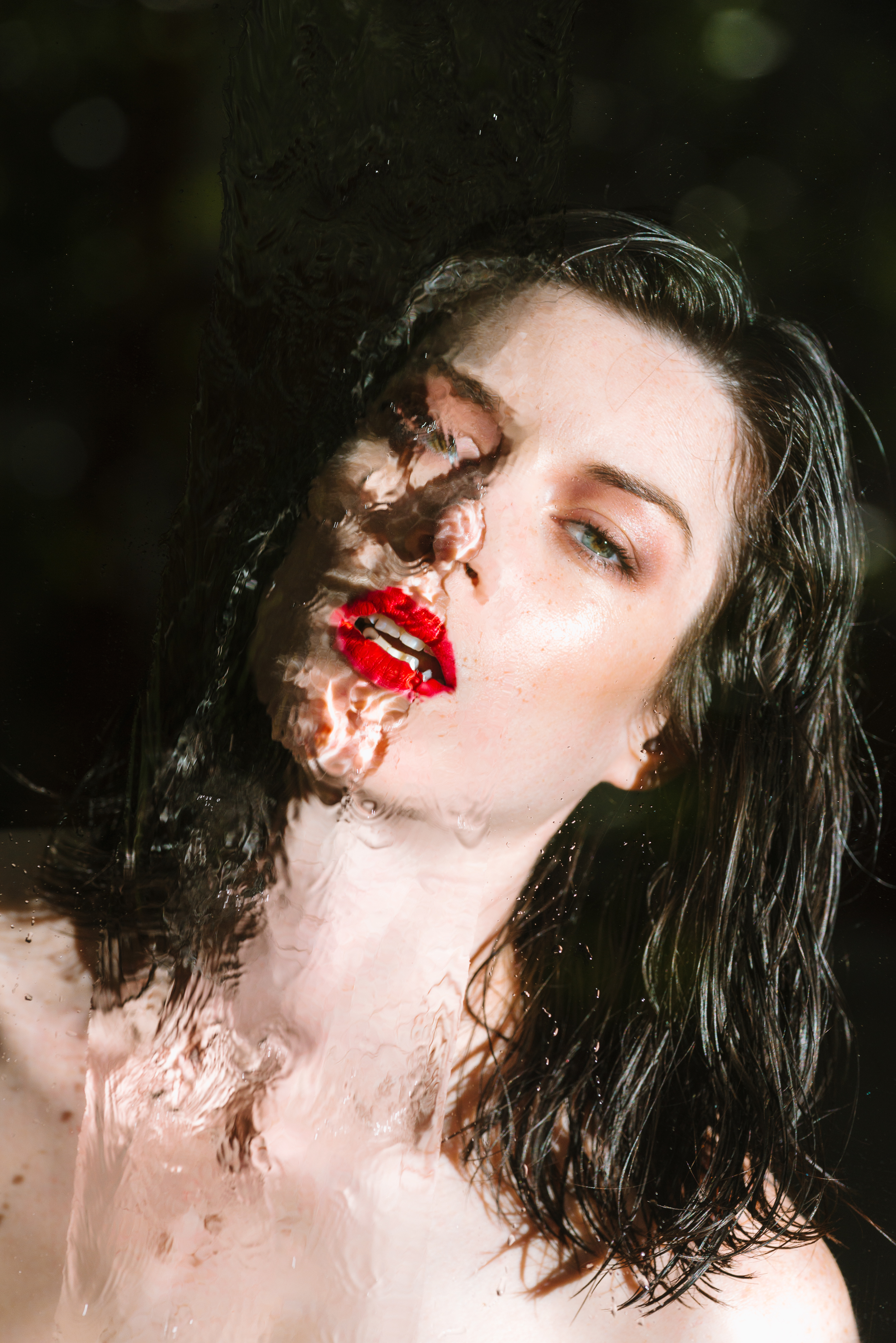 Woman with red lipstick behind water HD Wallpaper