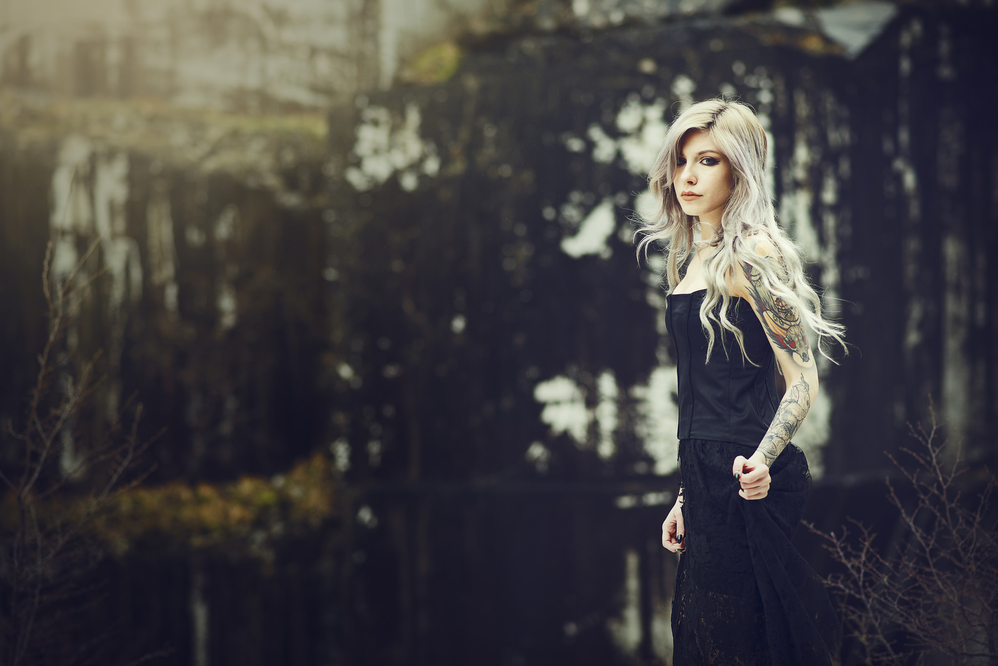 Woman with tattoos in a black dress near water HD Wallpaper