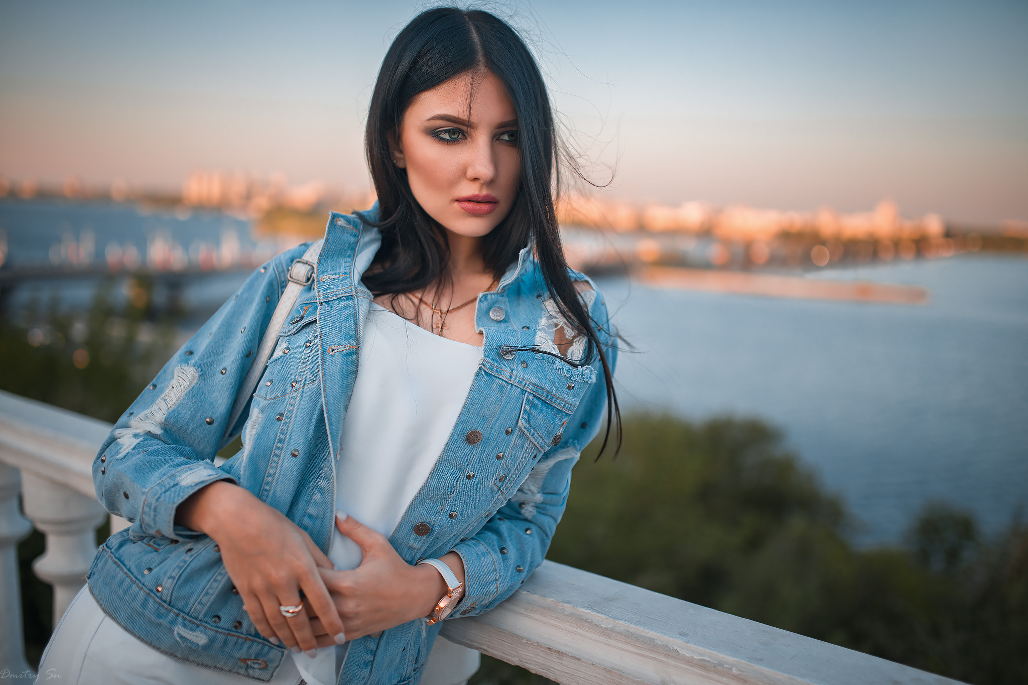 Woman in denim jacket looking away by a river HD Wallpaper