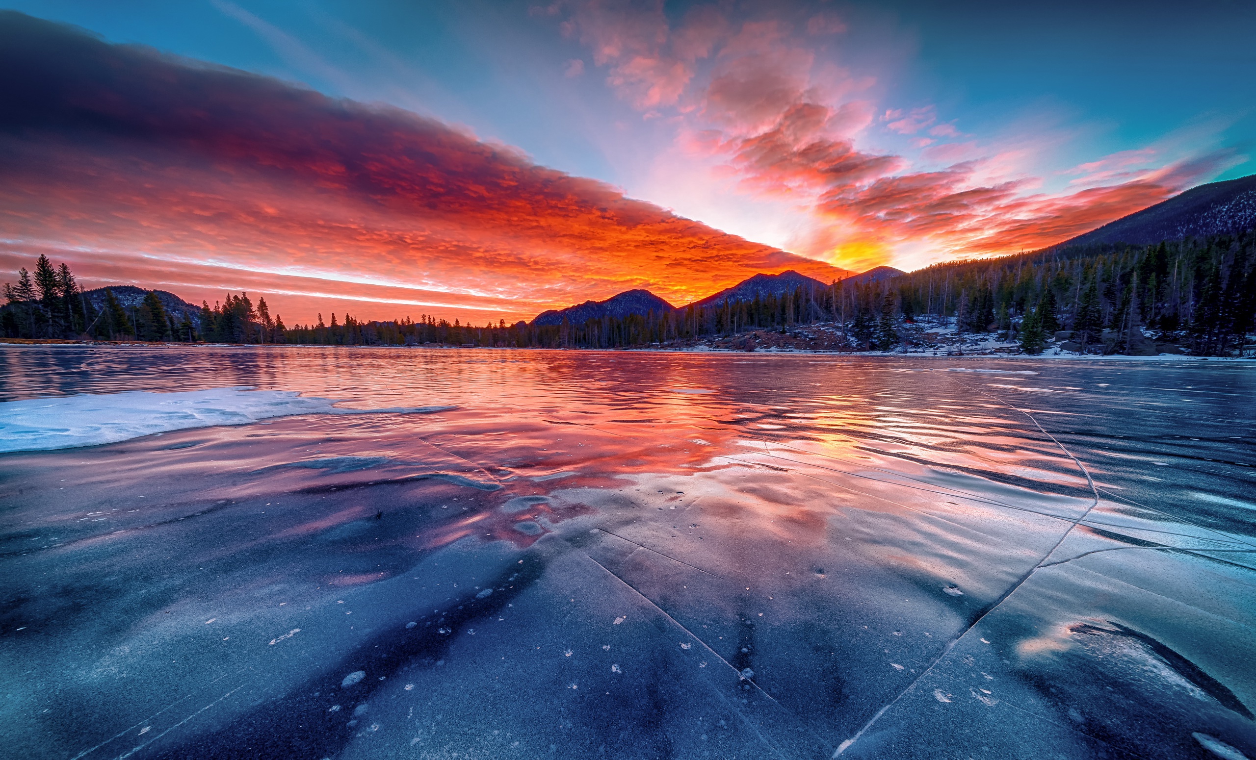 Frozen lake at sunrise with colorful clouds and mountains HD Wallpaper