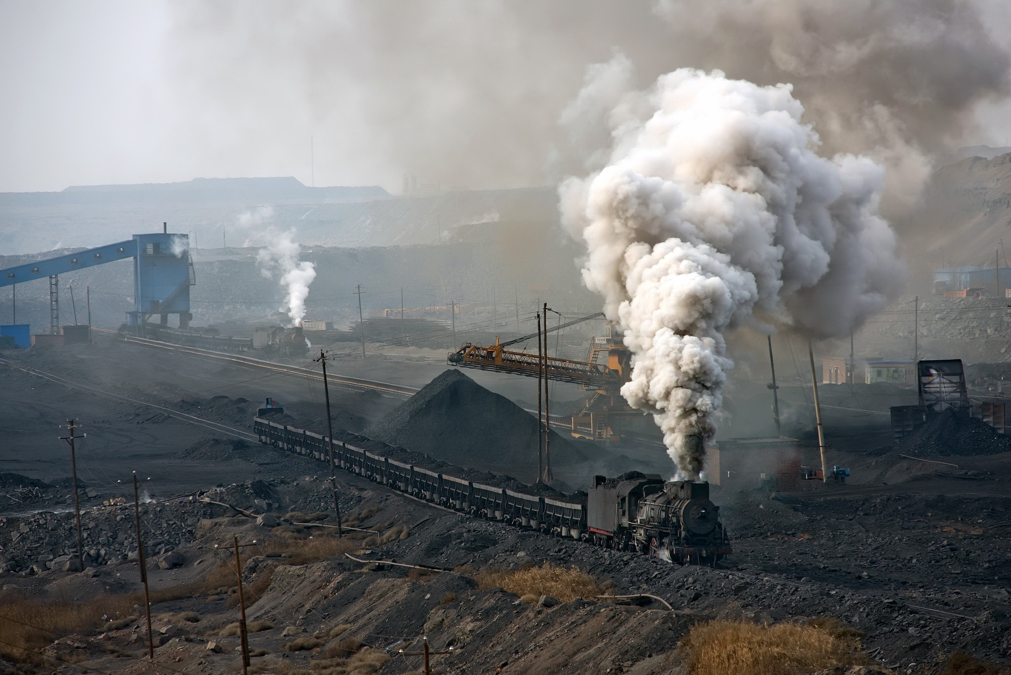 Steam locomotive hauling coal cars in a mine HD Wallpaper