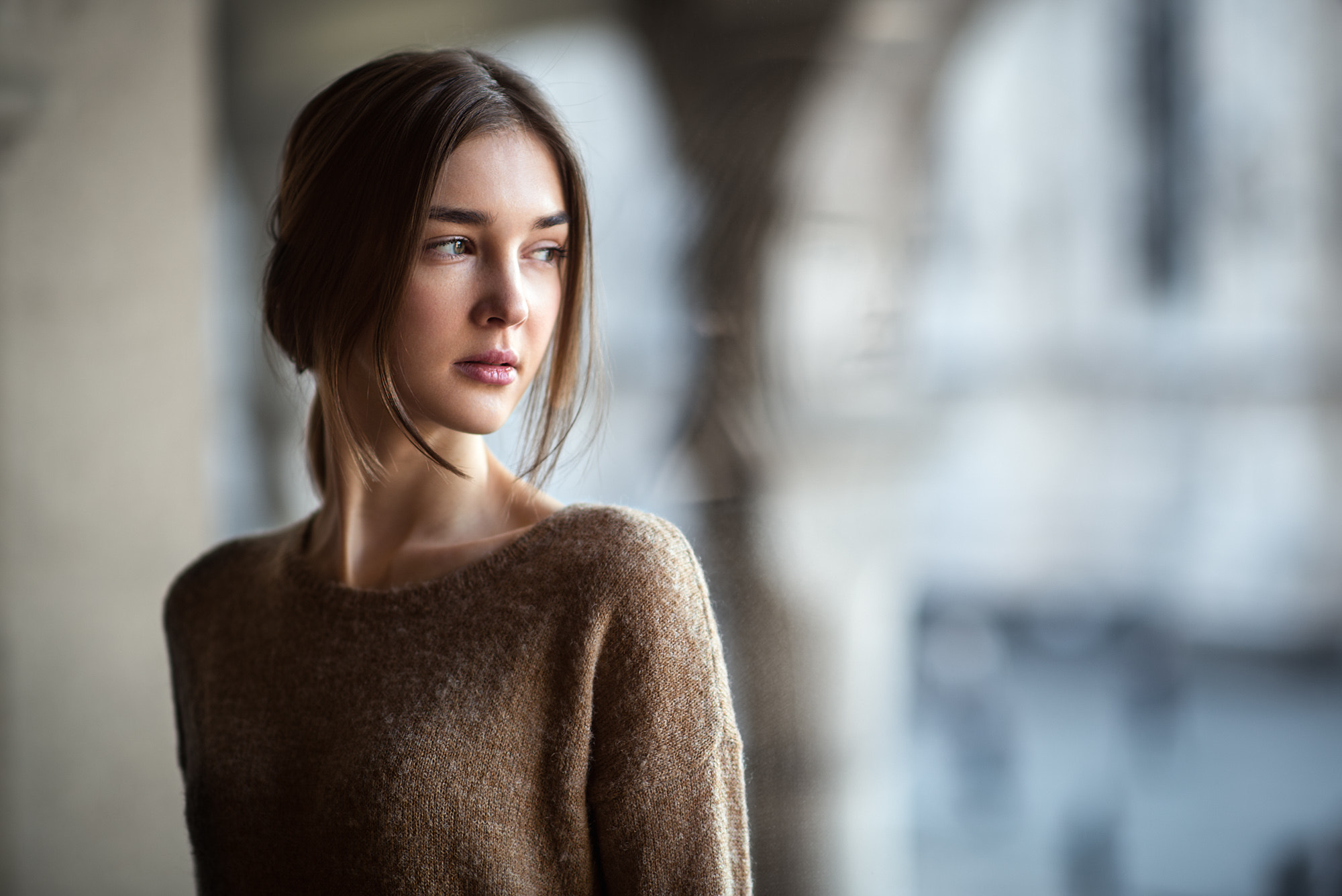 Woman in a brown sweater looking away HD Wallpaper