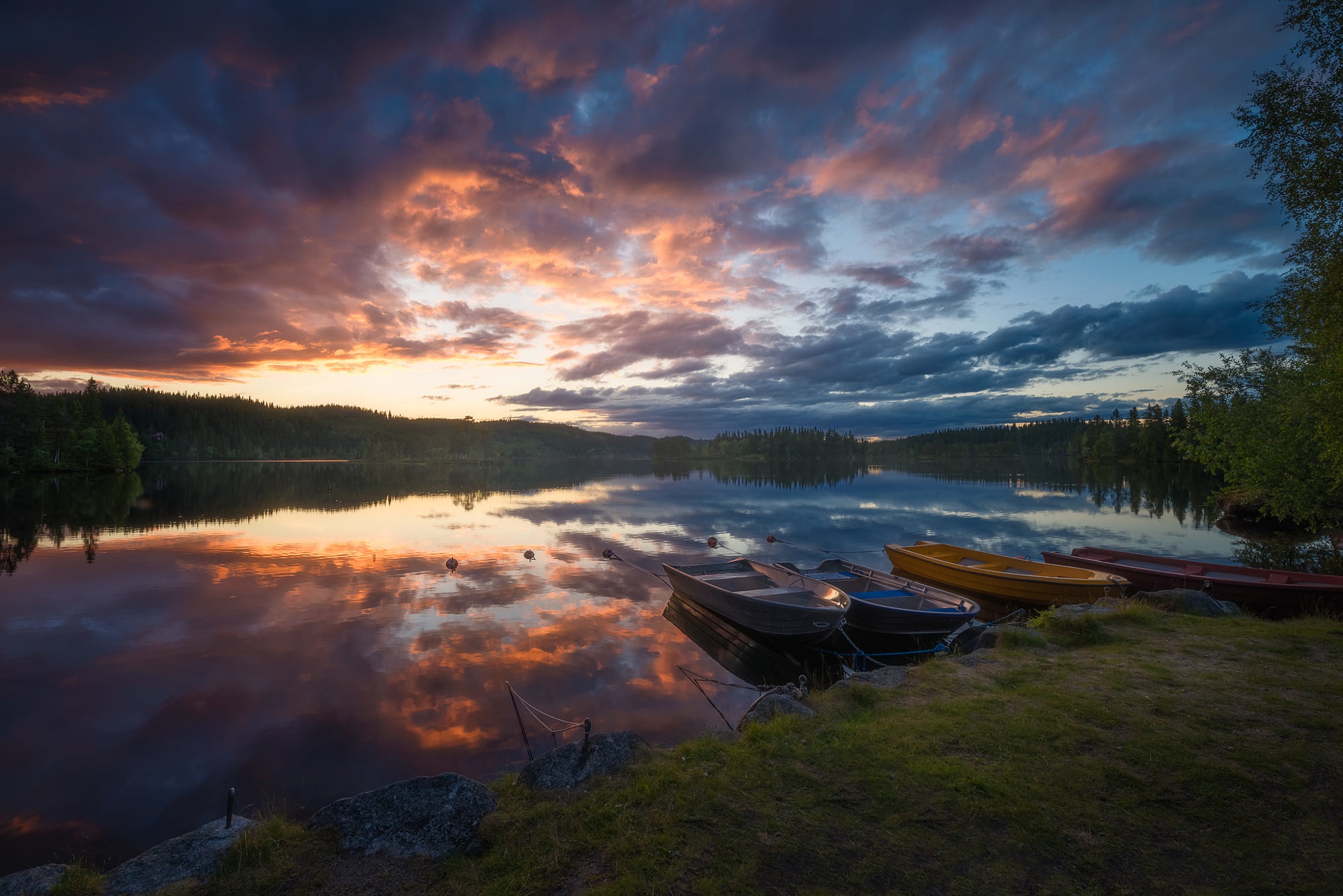 Boats on a lake at sunset with colorful clouds HD Wallpaper