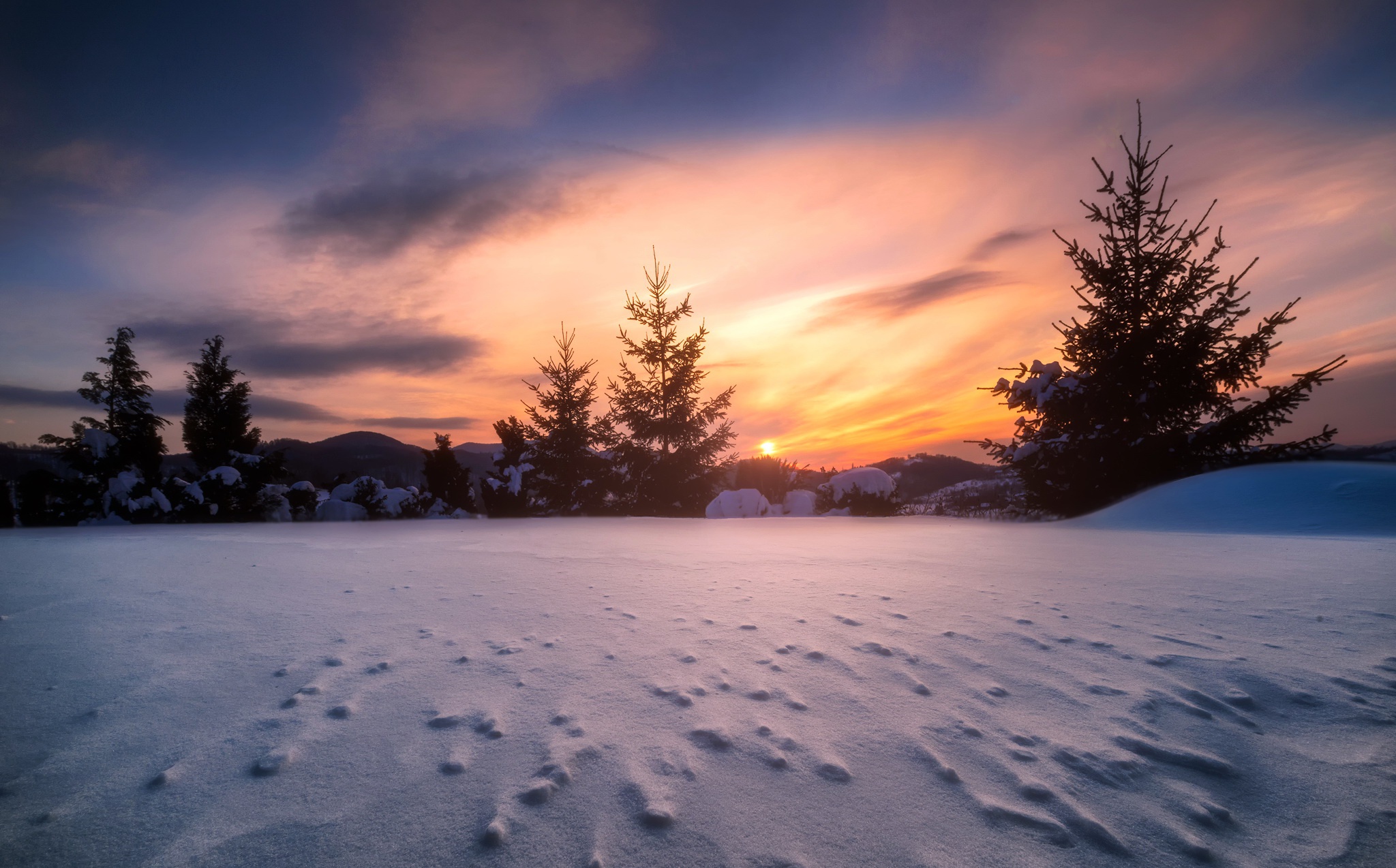 Winter sunset over snow-covered landscape with trees HD Wallpaper