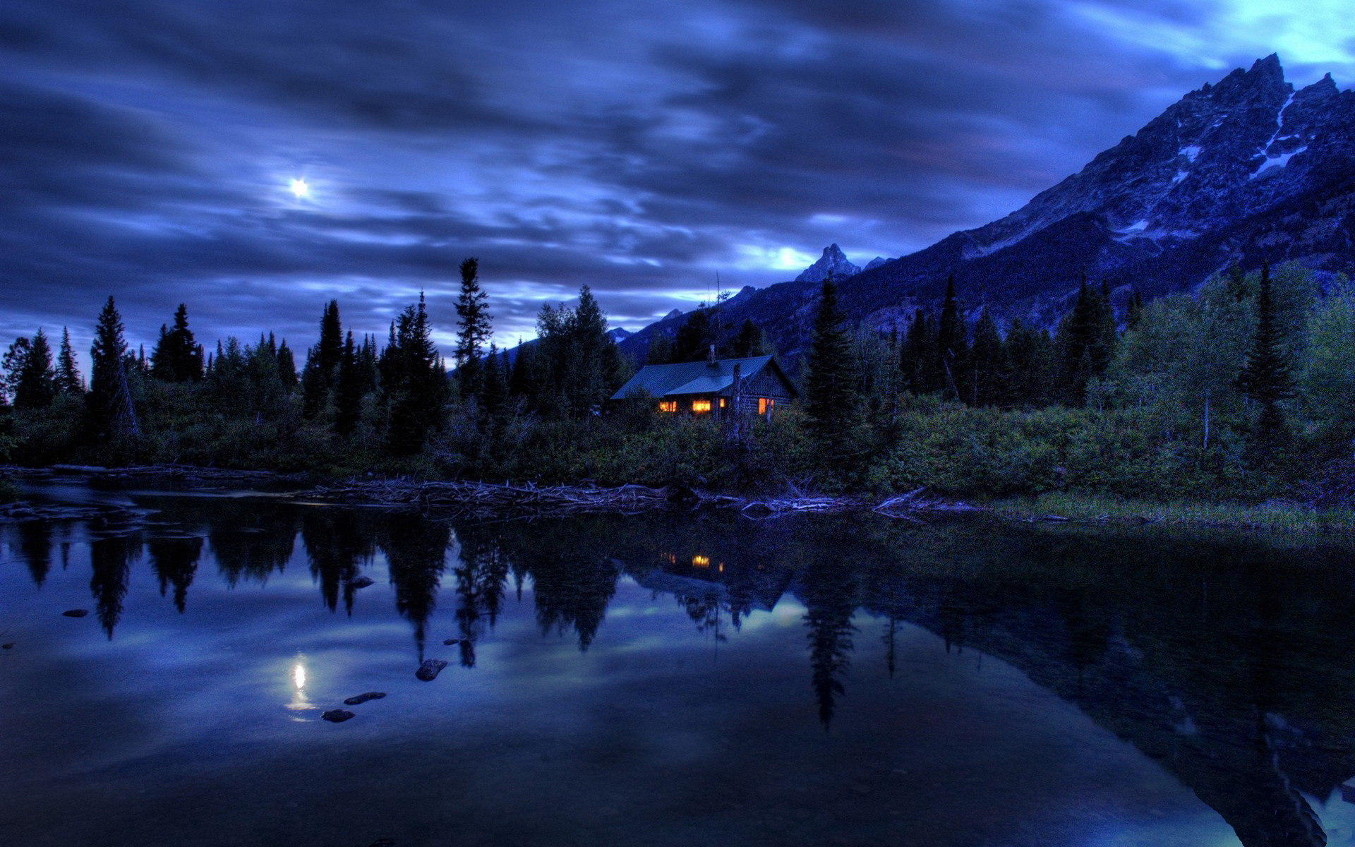 Cabin by a lake at night with mountains HD Wallpaper