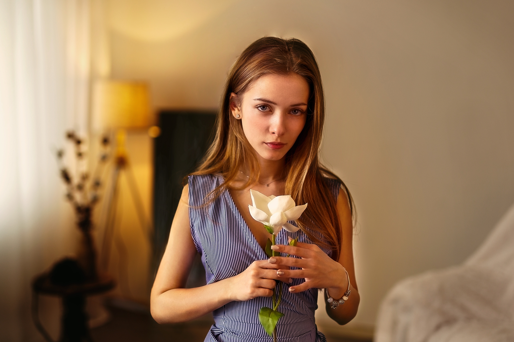 Woman holding a white flower indoors HD Wallpaper