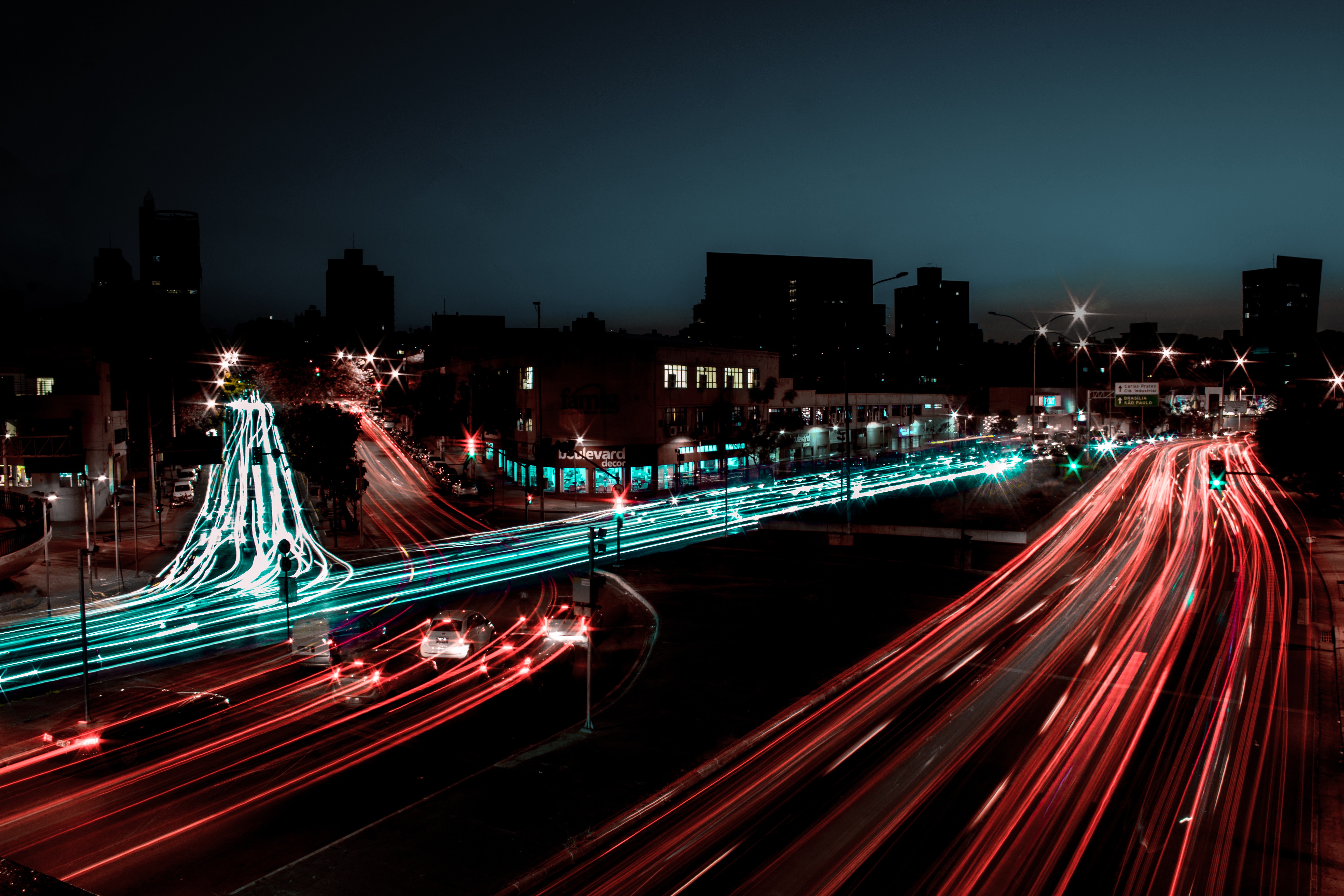 Cityscape at night with light trails from cars HD Wallpaper