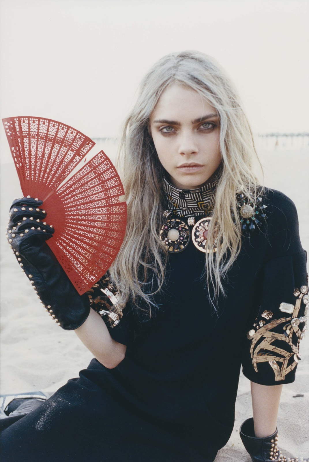 Cara Delevingne with red fan on beach HD Wallpaper