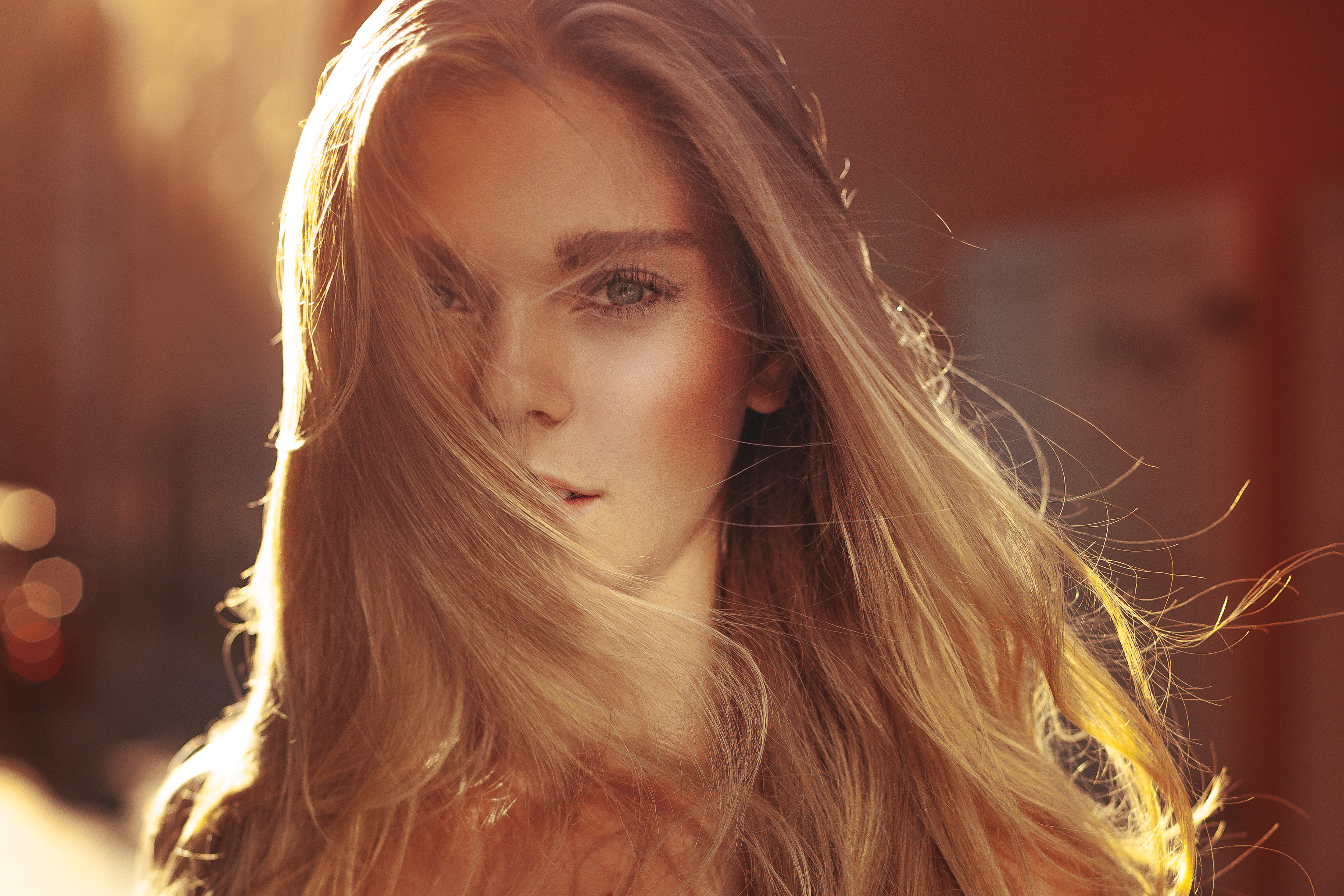 Portrait of a blonde woman with hair in her face HD Wallpaper