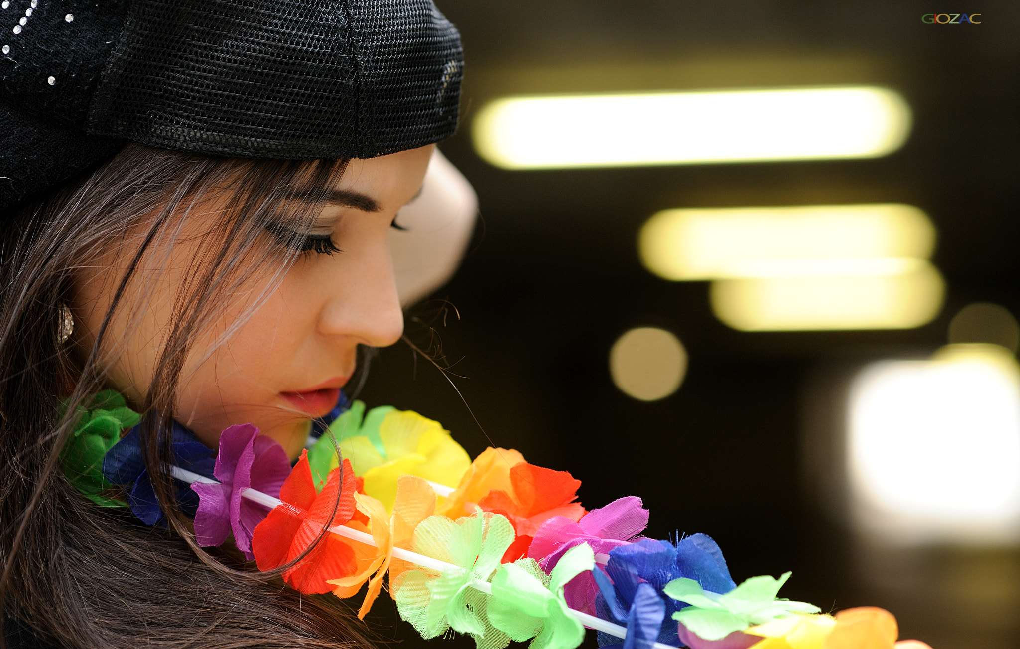 Portrait of a woman wearing a black cap and lei HD Wallpaper