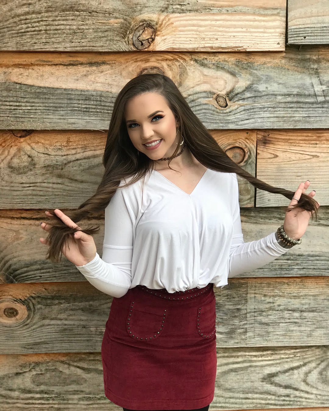 Woman with long brown hair wearing a white shirt and red skirt HD Wallpaper