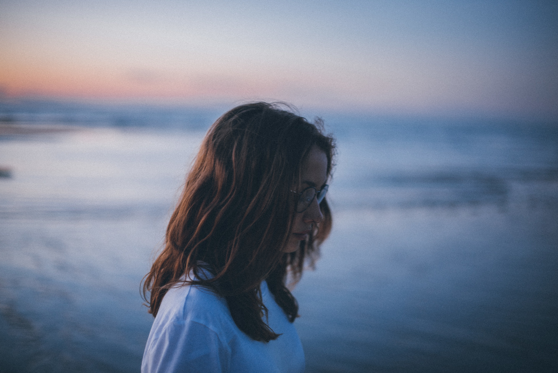 Woman with glasses on a beach at sunset HD Wallpaper