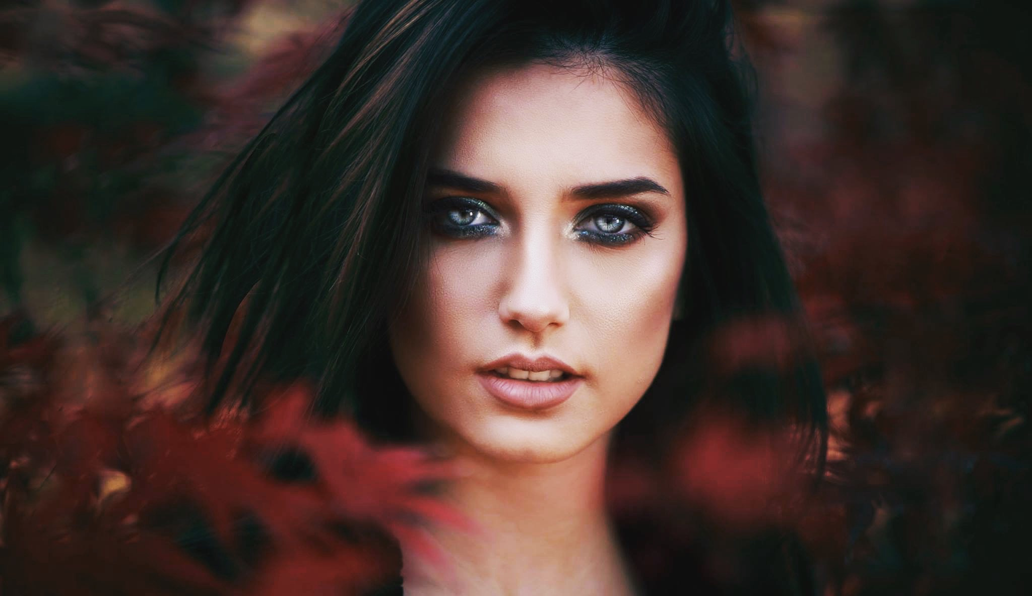 Woman with smoky eyes and dark hair outdoors HD Wallpaper