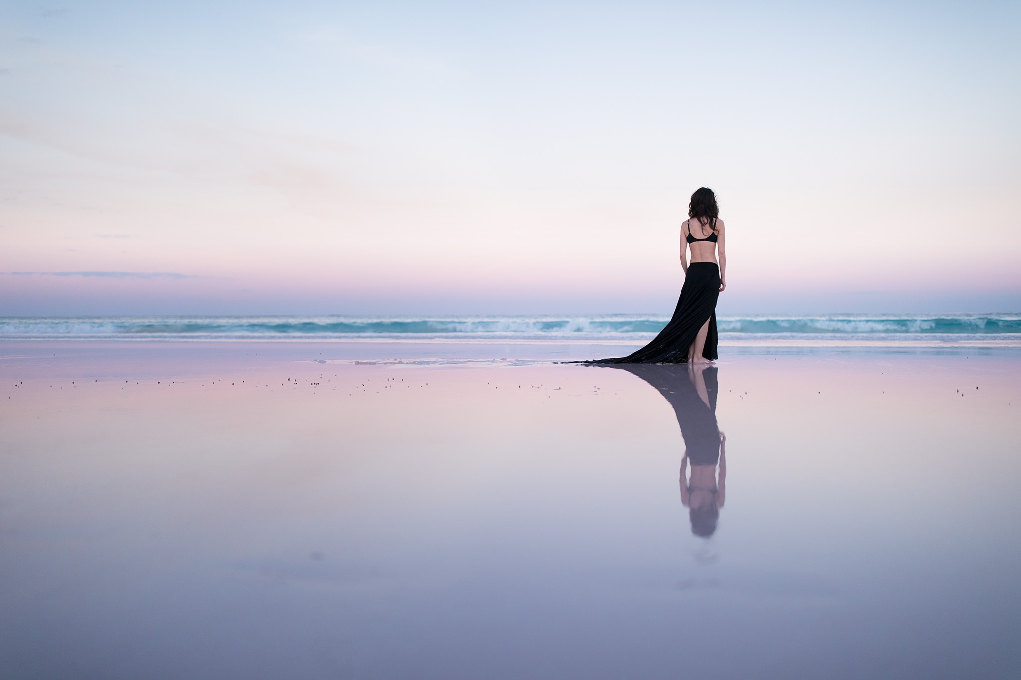 Woman in black dress on a beach at sunset HD Wallpaper