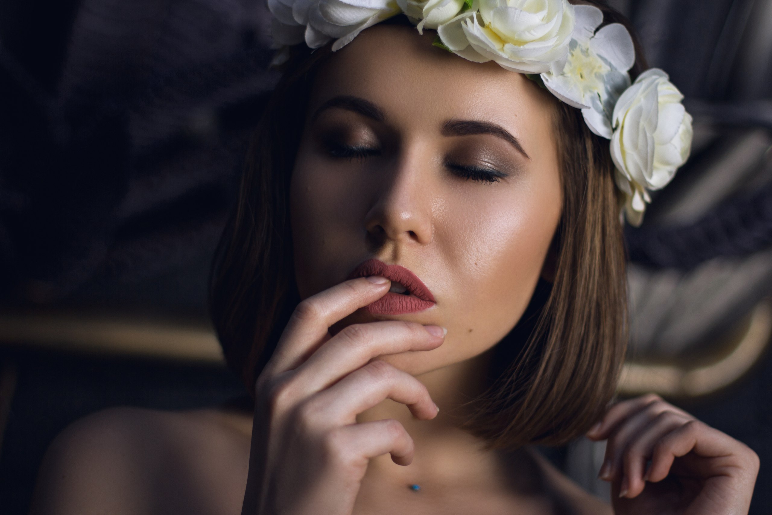 Woman with flower crown and finger on lips HD Wallpaper