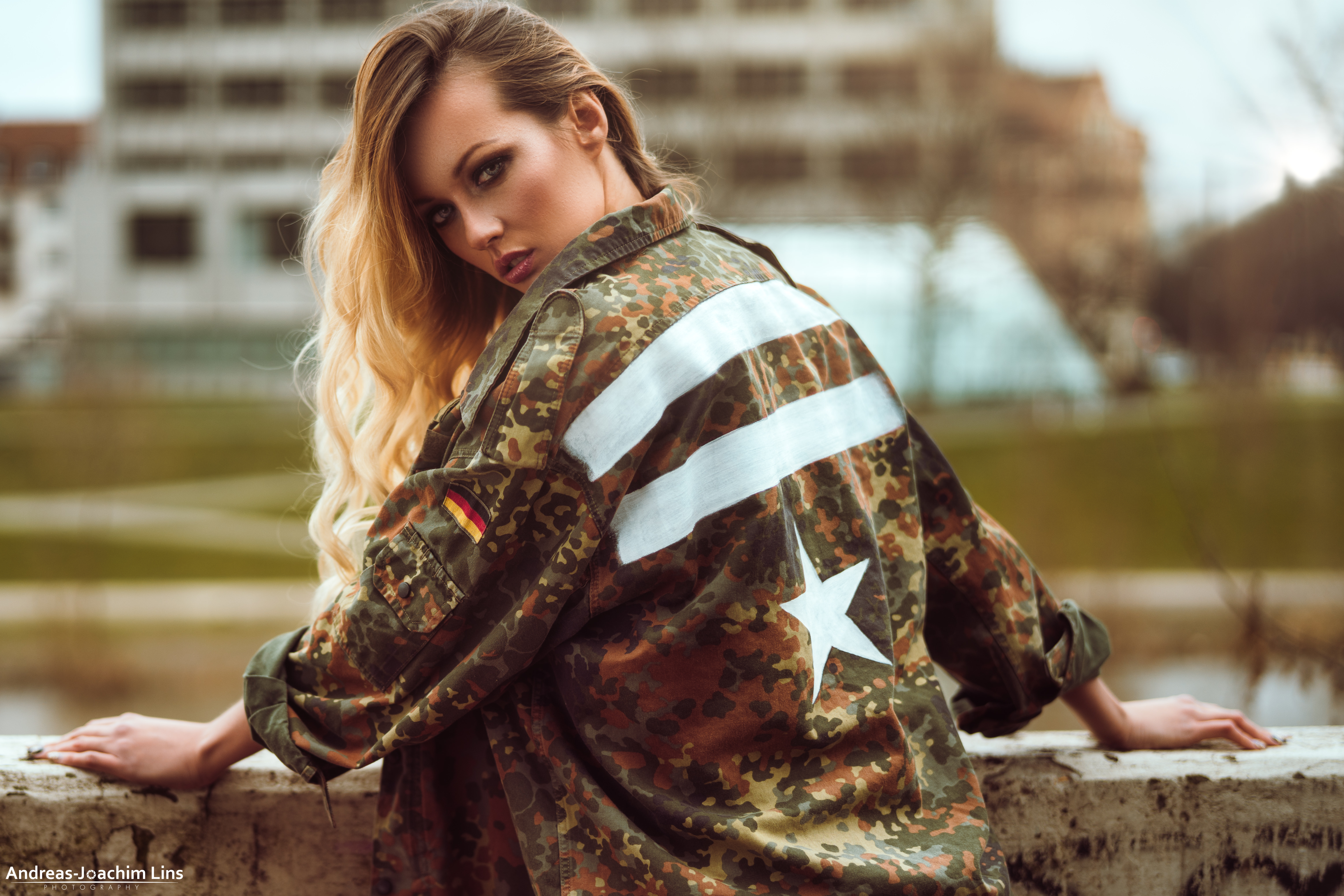 Woman in camouflage jacket with German flag HD Wallpaper