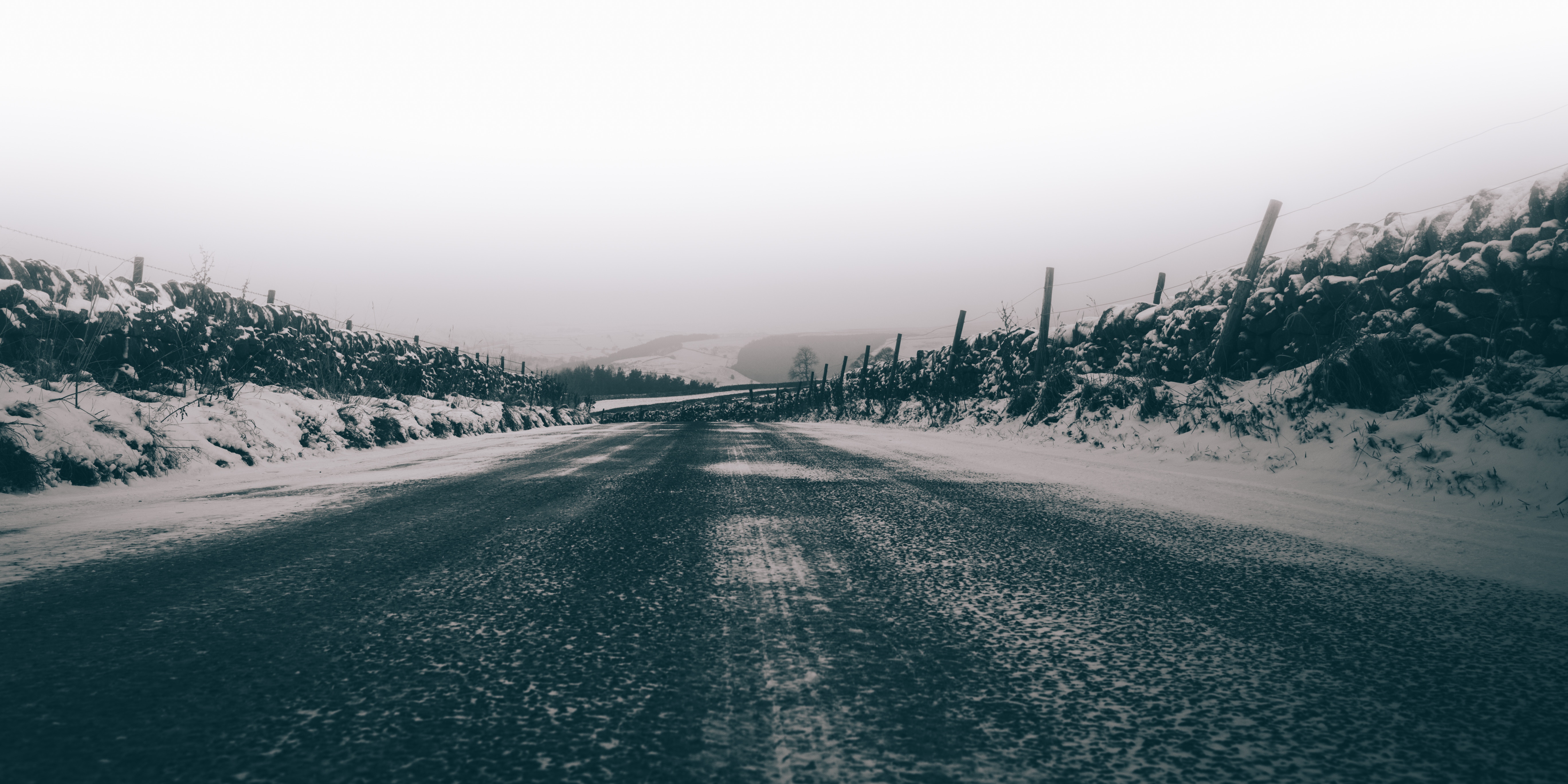 Snowy road with stone walls and fog HD Wallpaper