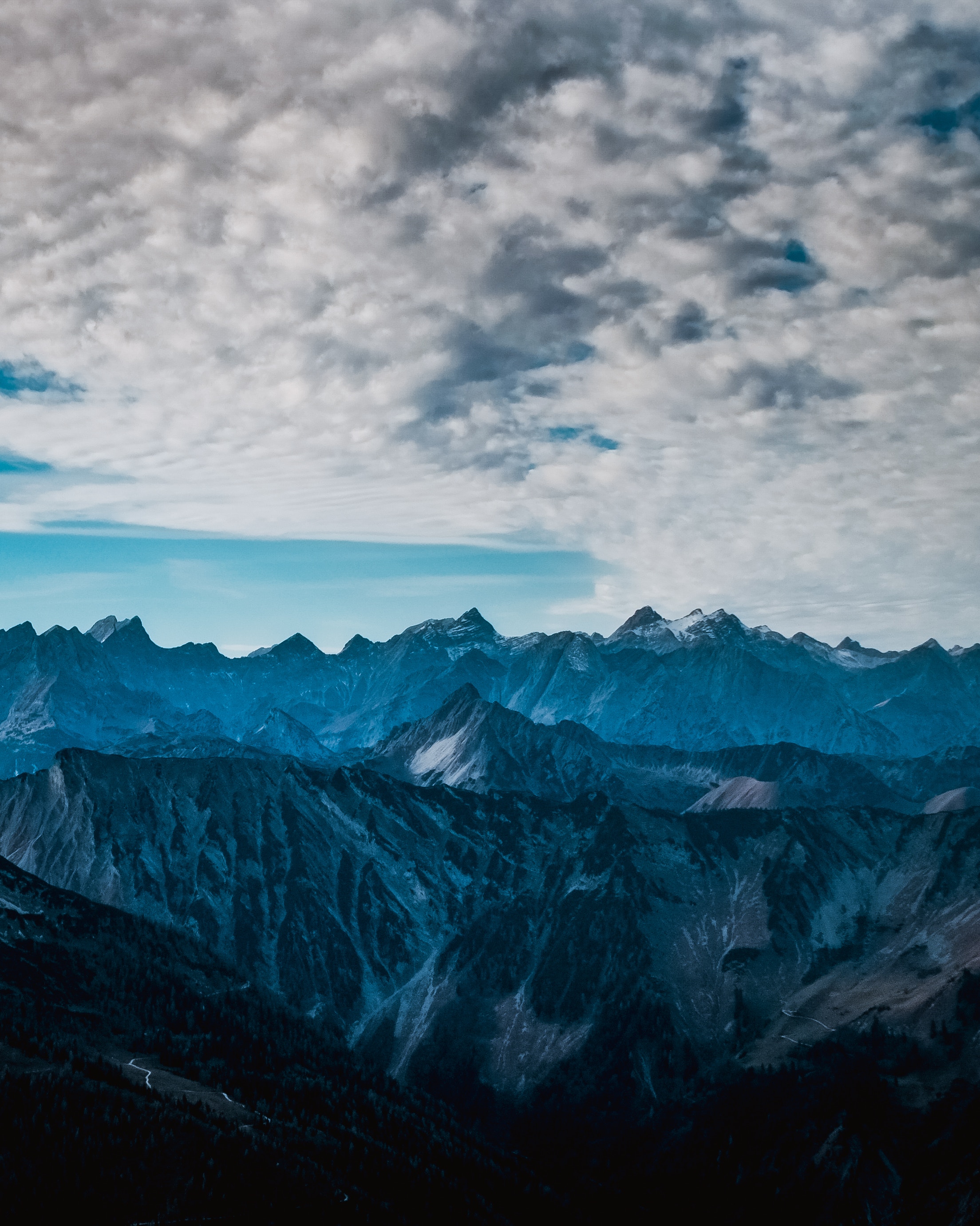 Mountain range under cloudy sky HD Wallpaper