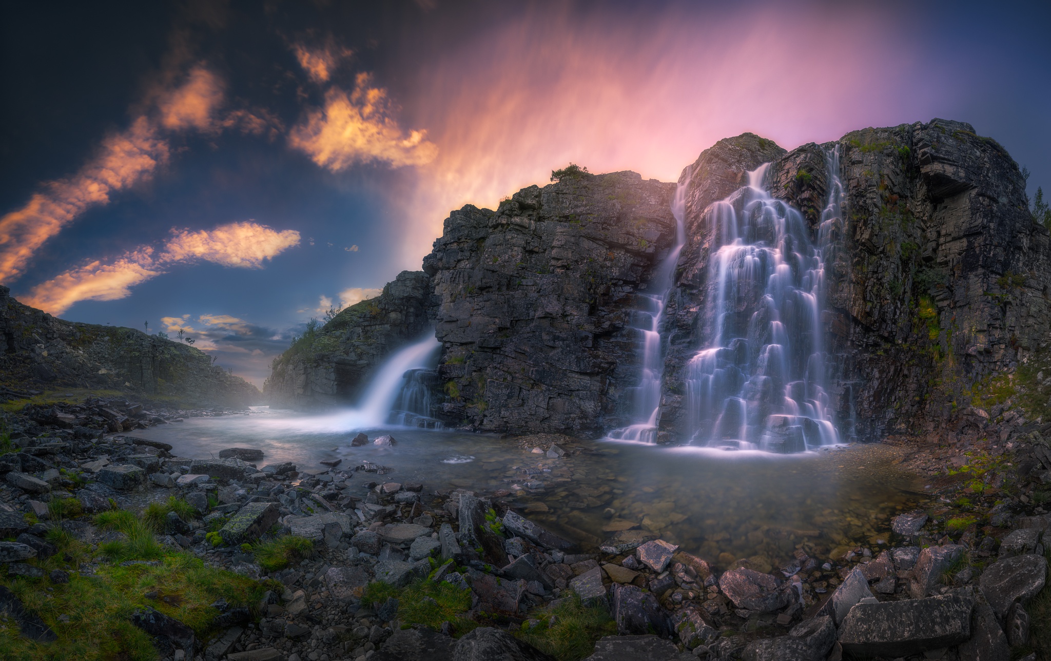 Long exposure waterfall in rocky landscape at sunset HD Wallpaper