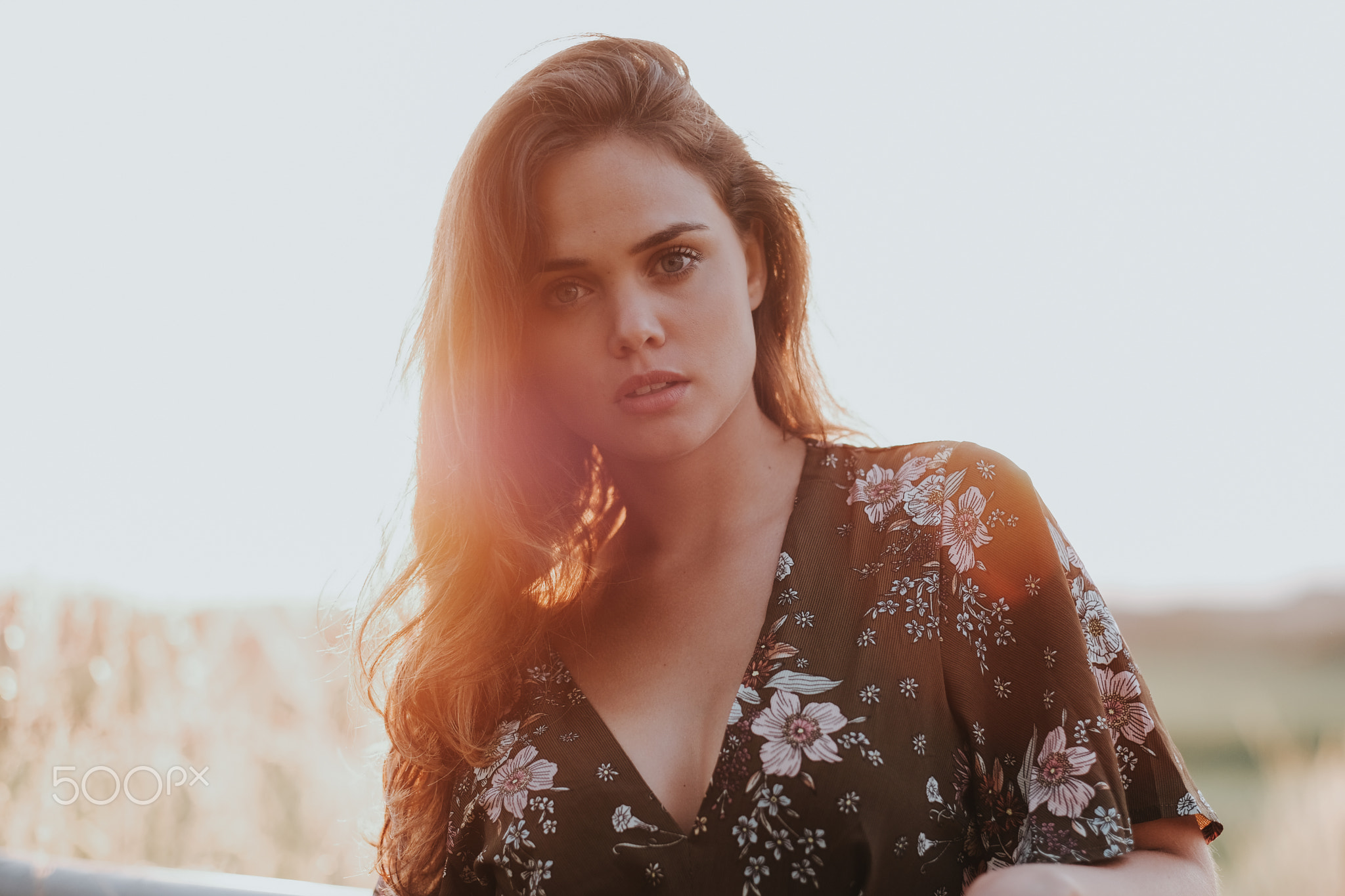 Woman in floral dress outdoors at sunset HD Wallpaper