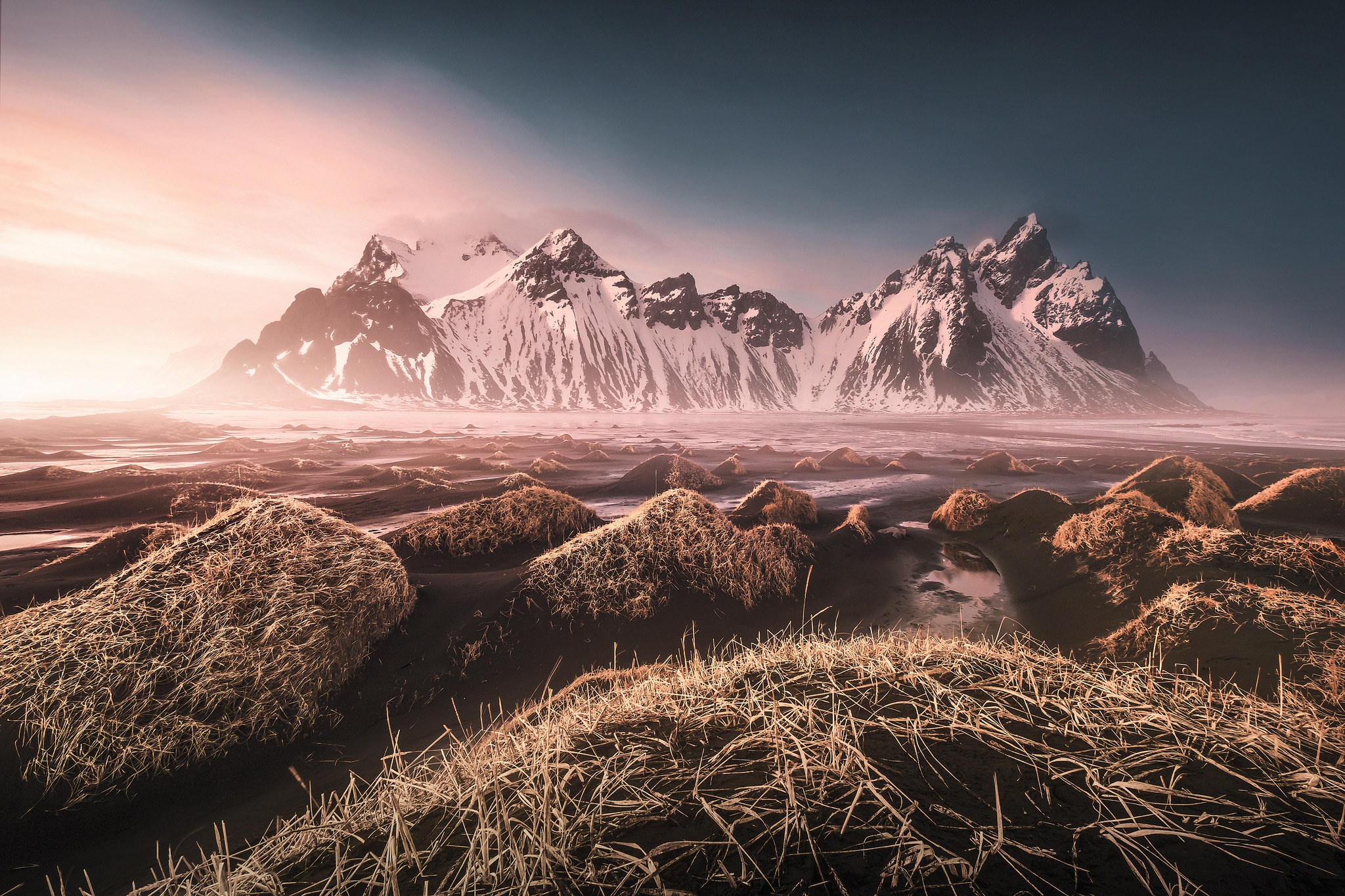 Snow-capped mountains in Iceland with foreground grass HD Wallpaper