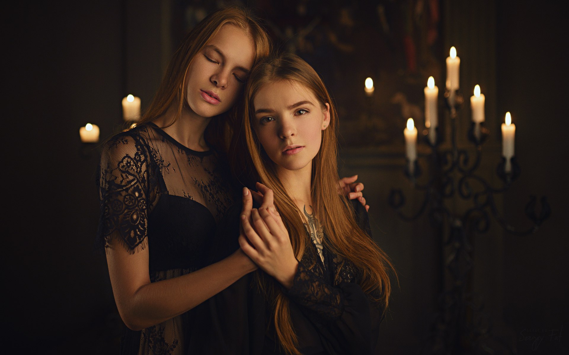 Two young women in black lace near candles HD Wallpaper